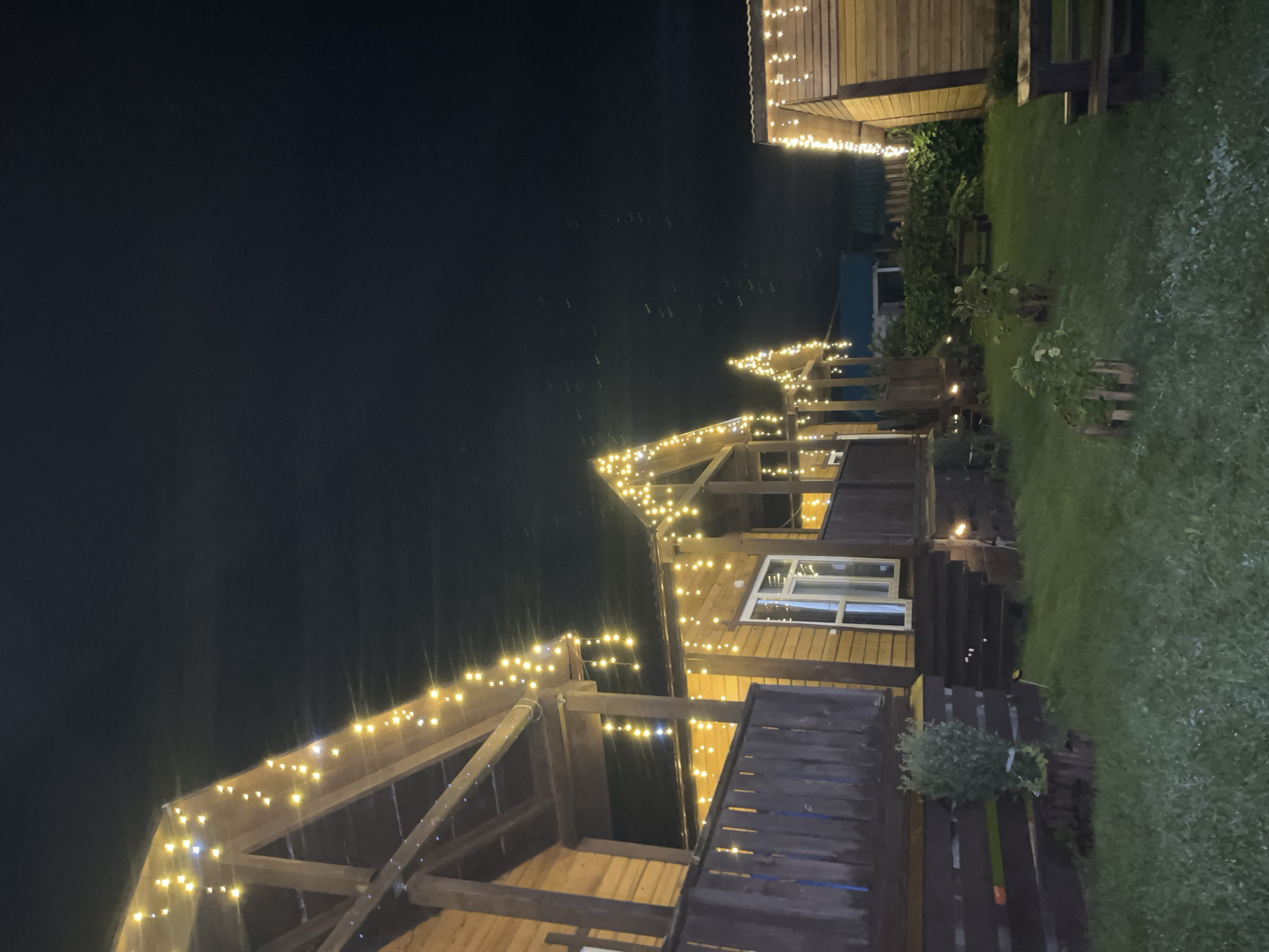 Fairy-lit wooden cabins glow in the Ust-Muny night