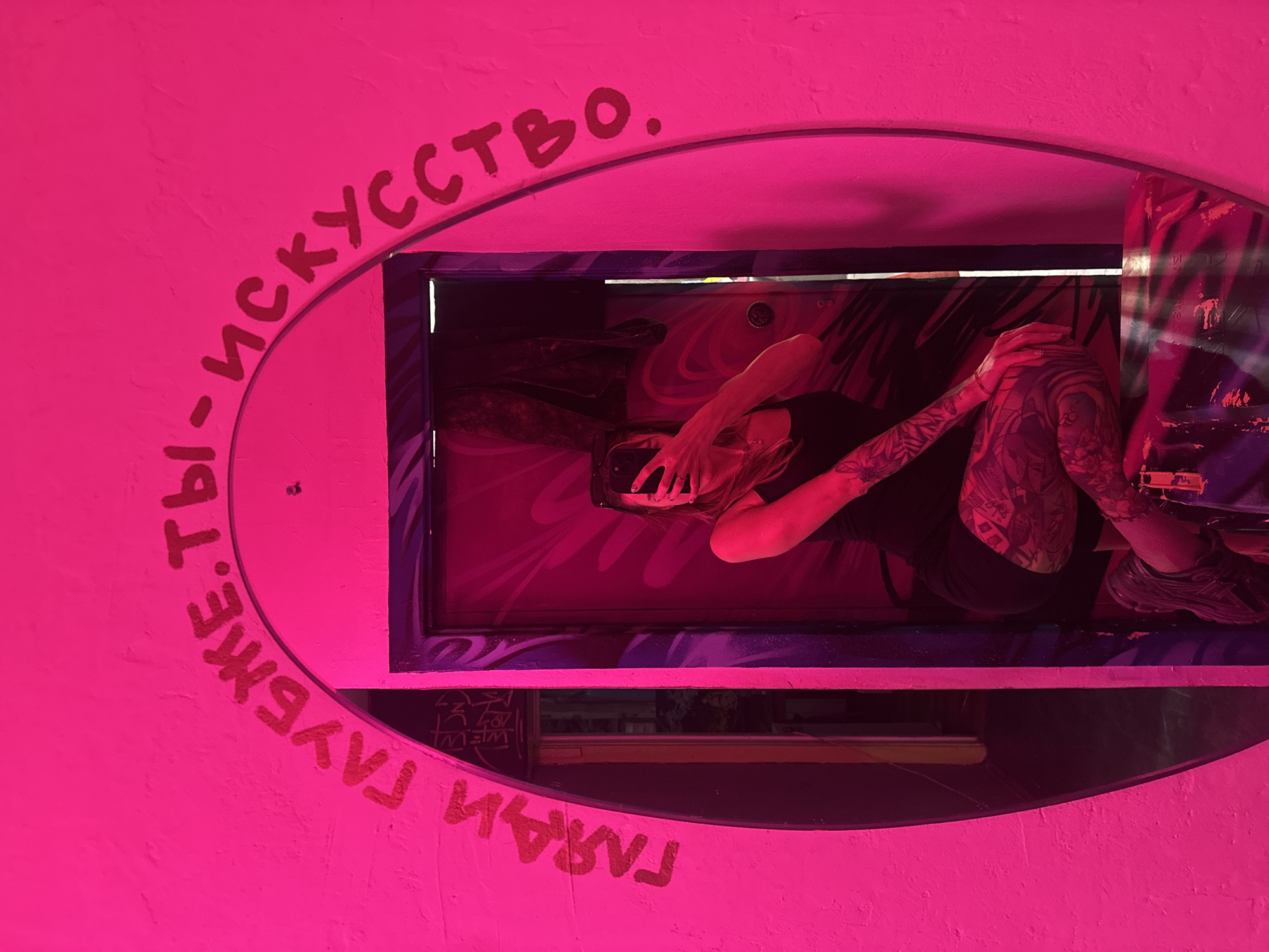 Person documents personal moments in artistic Moscow interior space
