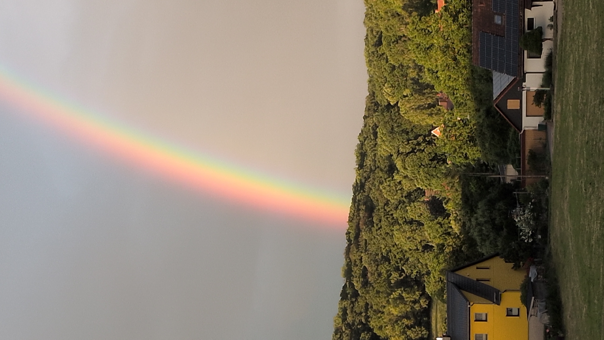 Rainbow over Rastenberg with garden watering and candy bowl