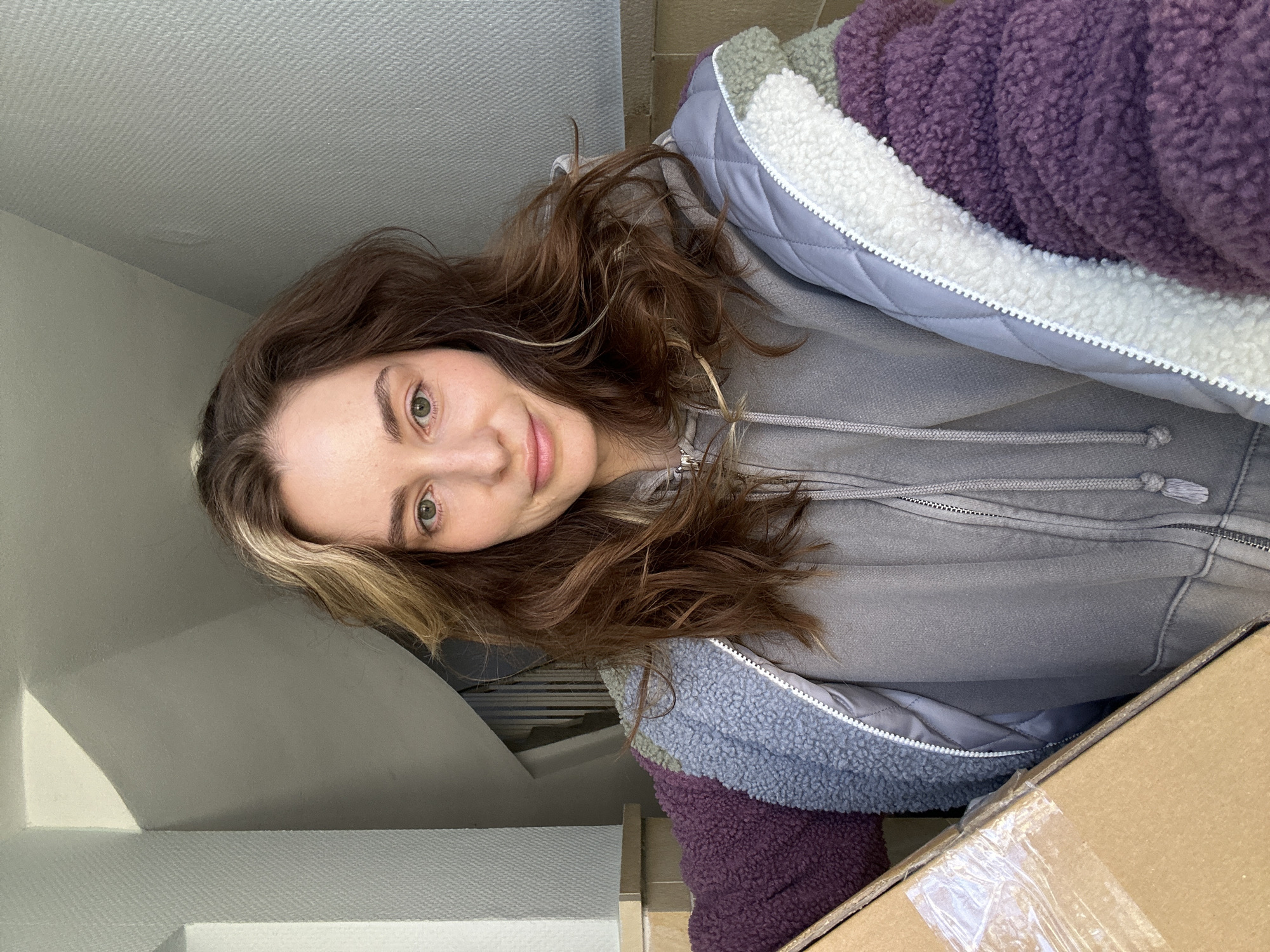 Woman records selfies indoors in Kiel, Germany