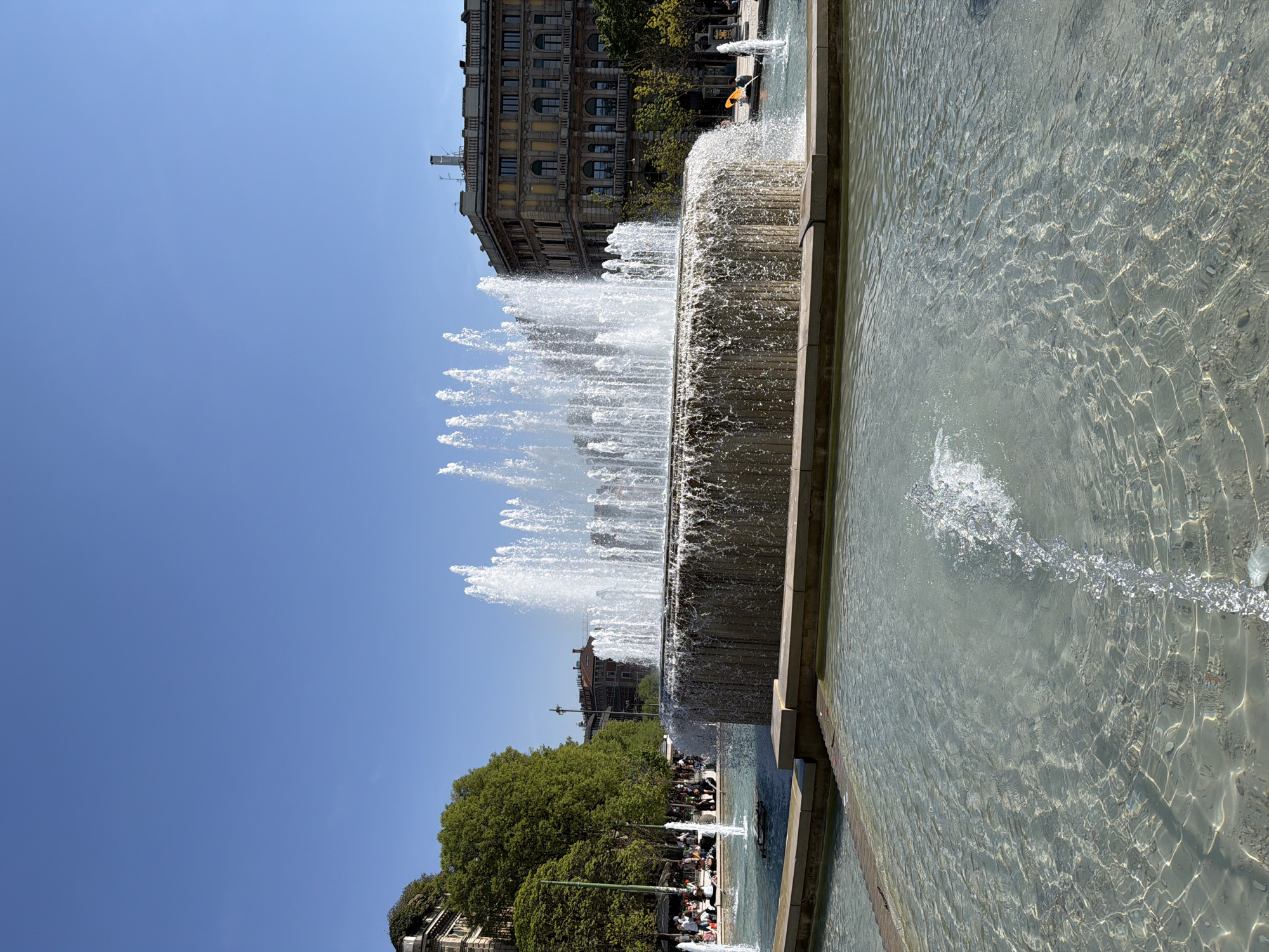 Sunny afternoon crowds gather at Milan's historic center