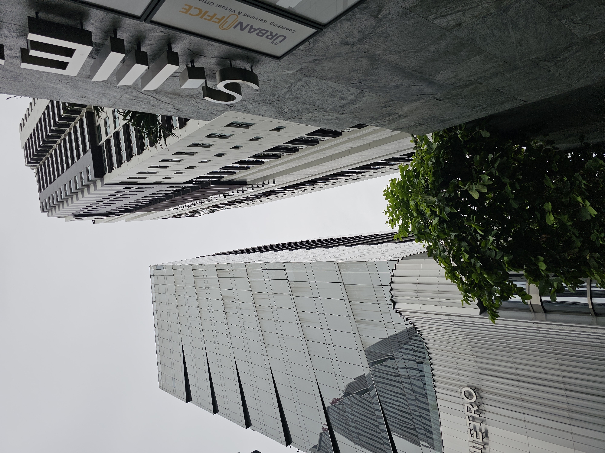 Plant market and city architecture along a Bangkok street