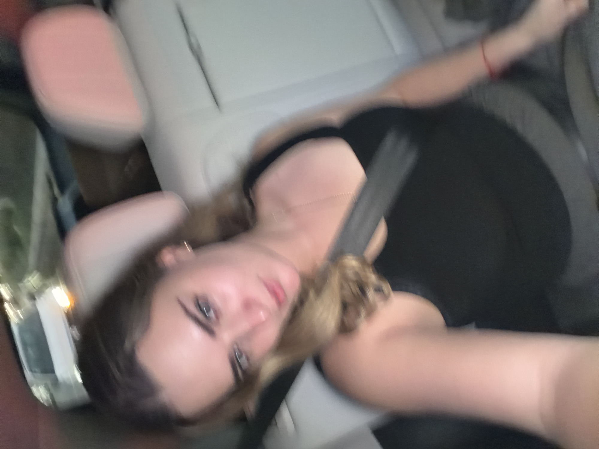 Person photographed reclining in car in Tlaxcalancingo, Mexico