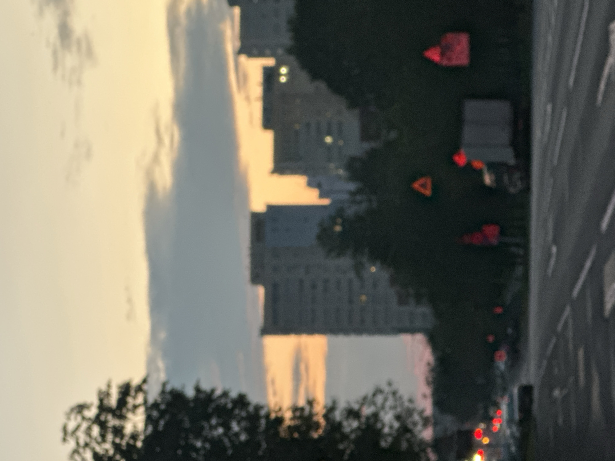 Dusk to night on city streets lined with apartment towers