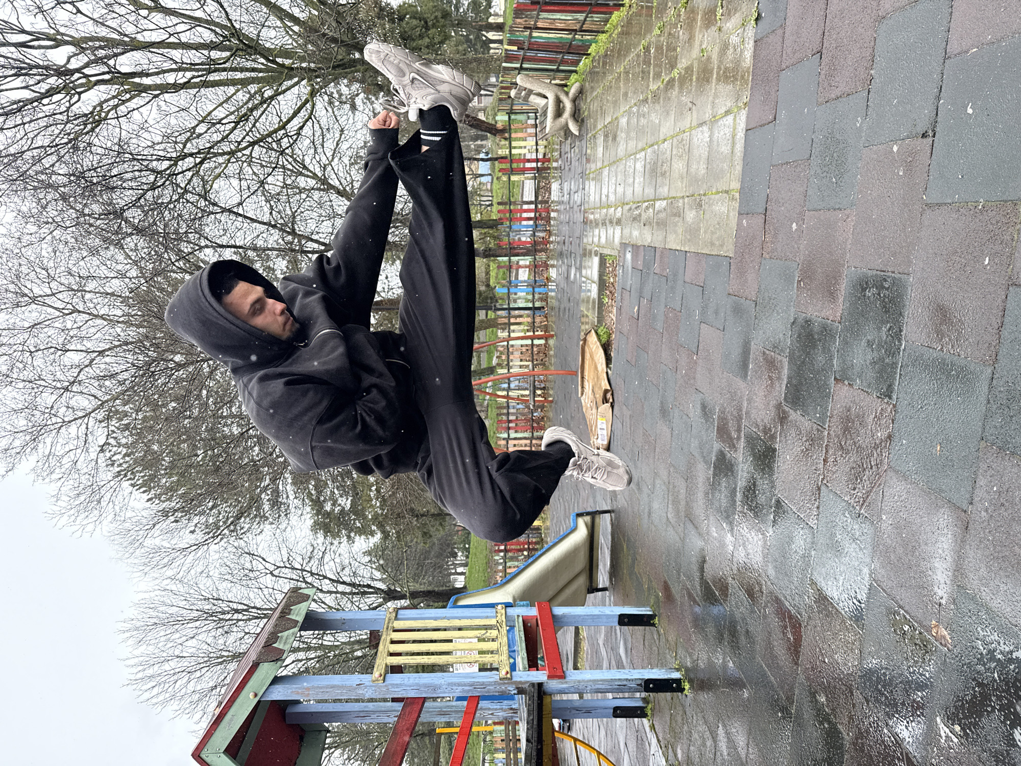 Person exercises and shelters at Shumen playground during overcast weather