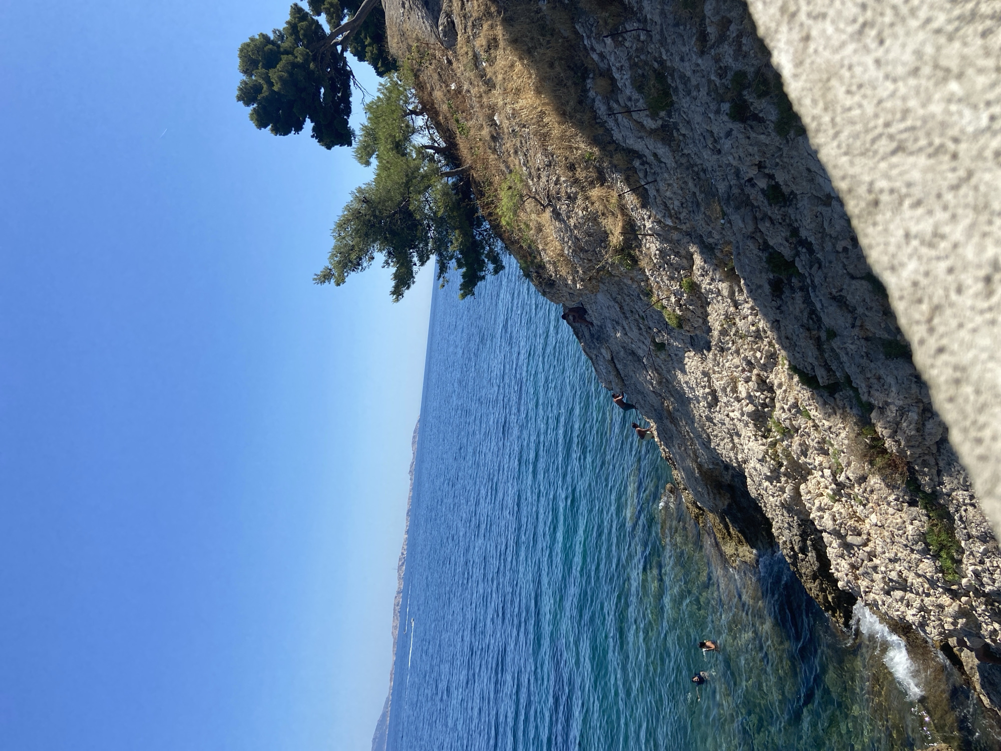 Rocky Mediterranean coast and ancient aqueduct on a clear summer day