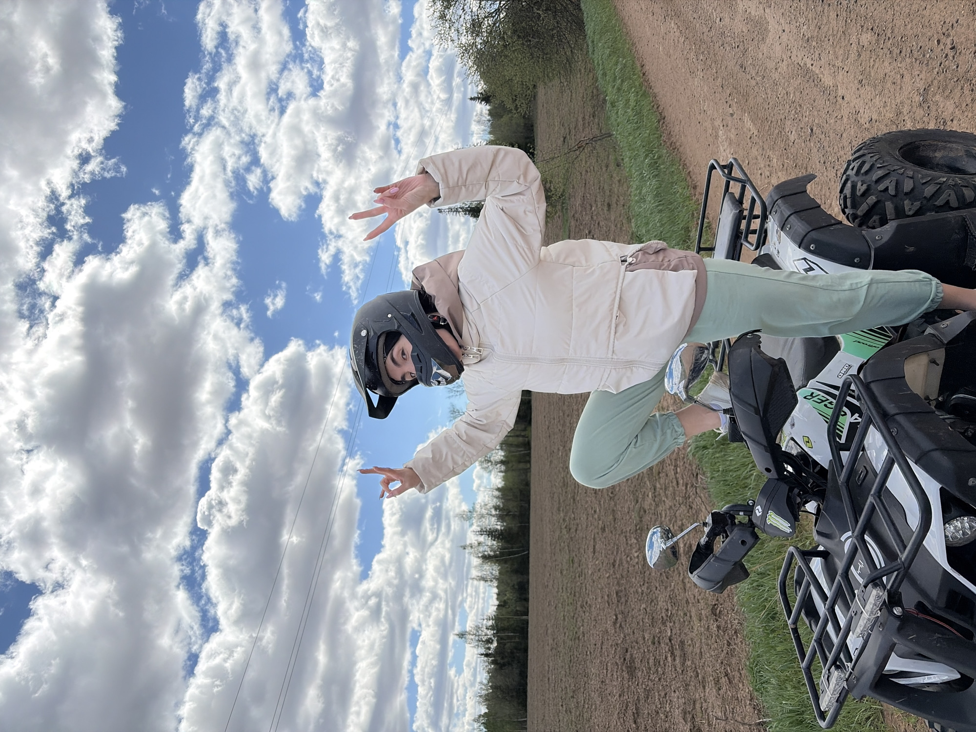 Woman poses with ATV on rural roads near Можга
