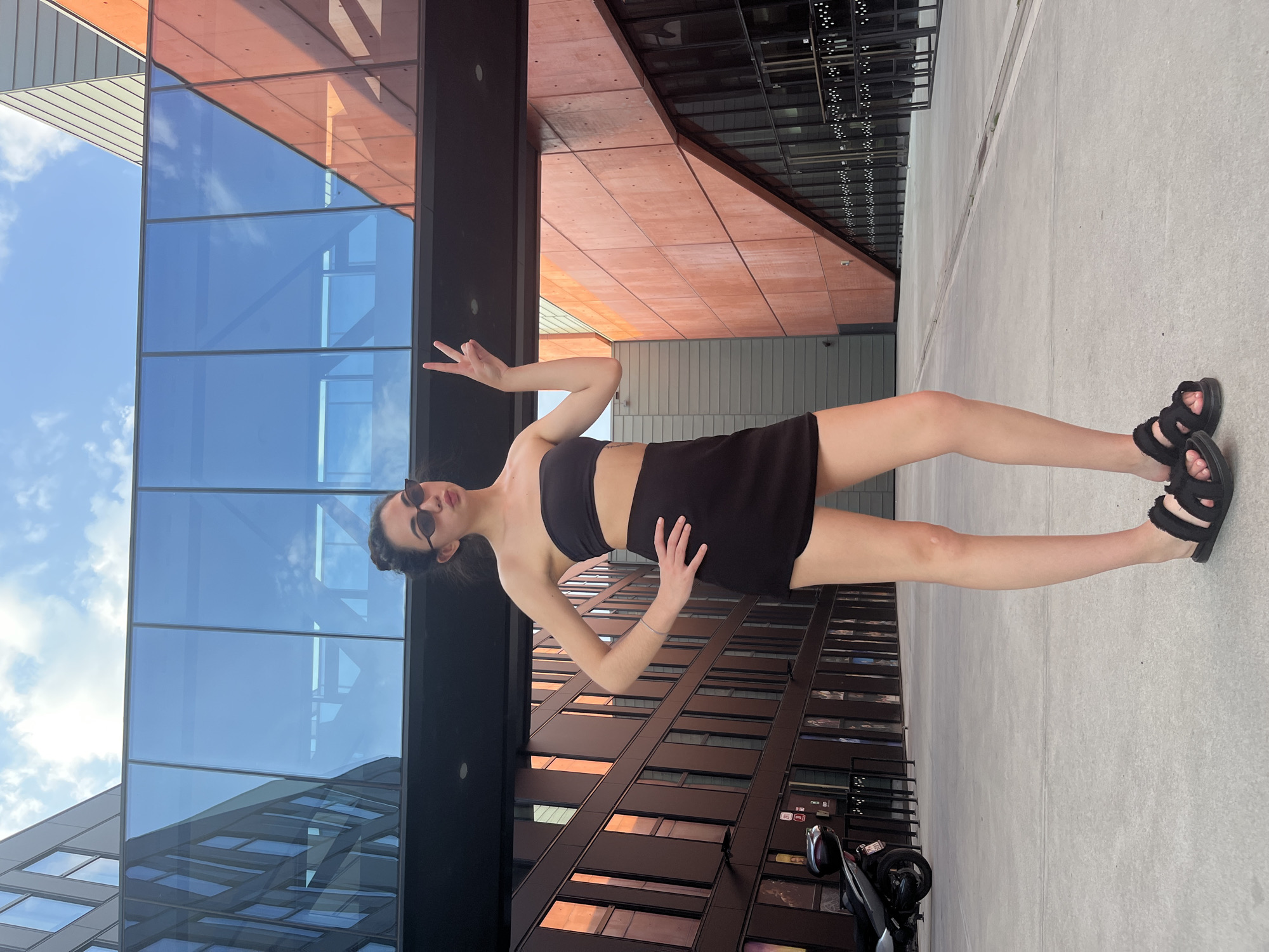 Posing around a spherical sculpture at a Pilsen plaza