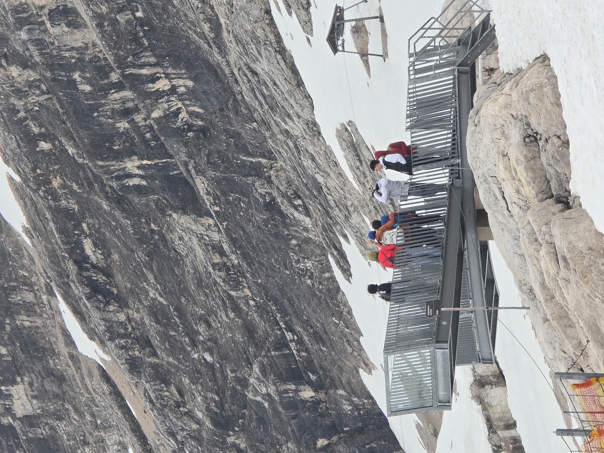 Visitor documents scenes at Zugspitze peak during midday tour