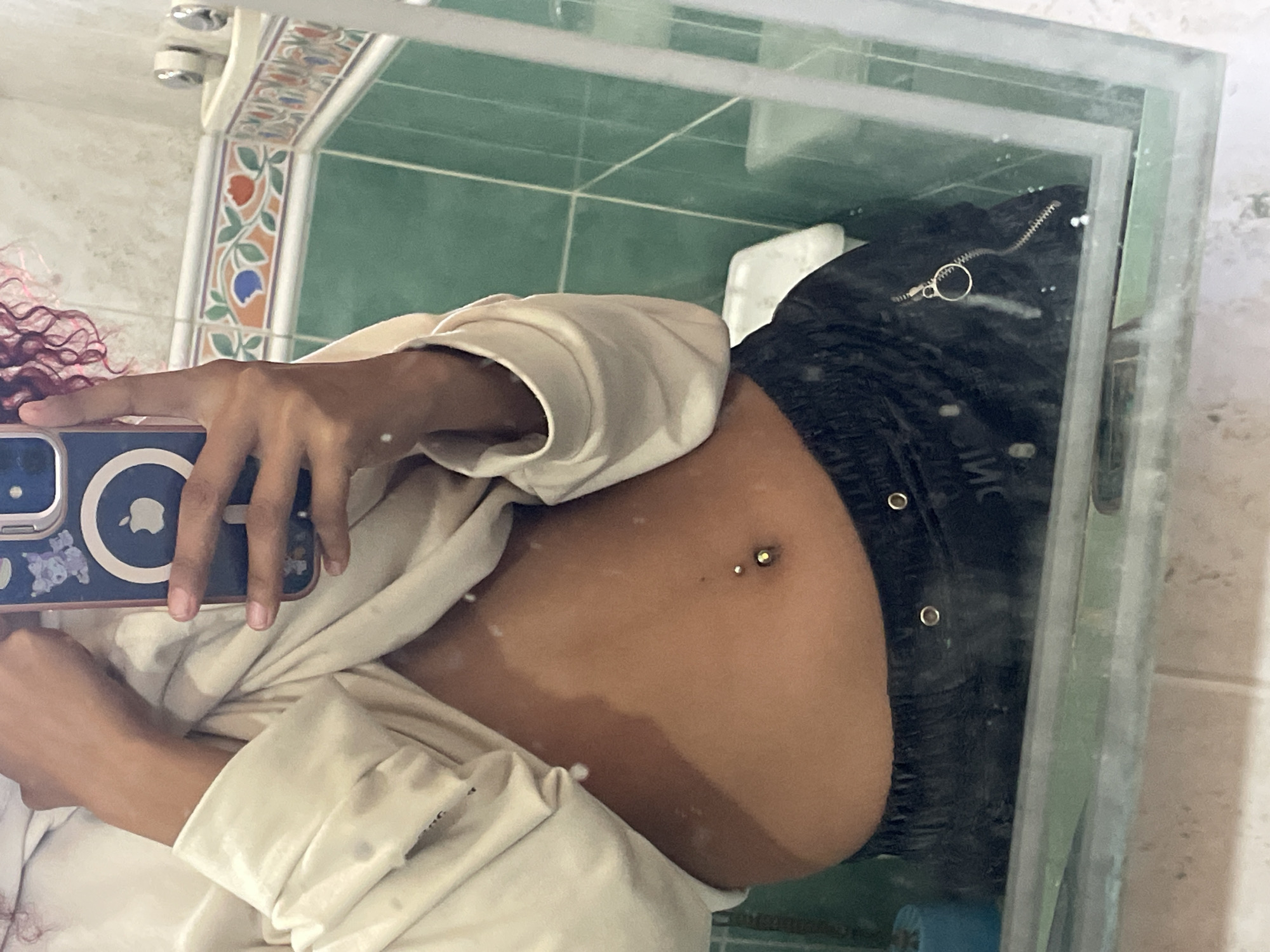 Person takes bathroom mirror selfie in Venezuela
