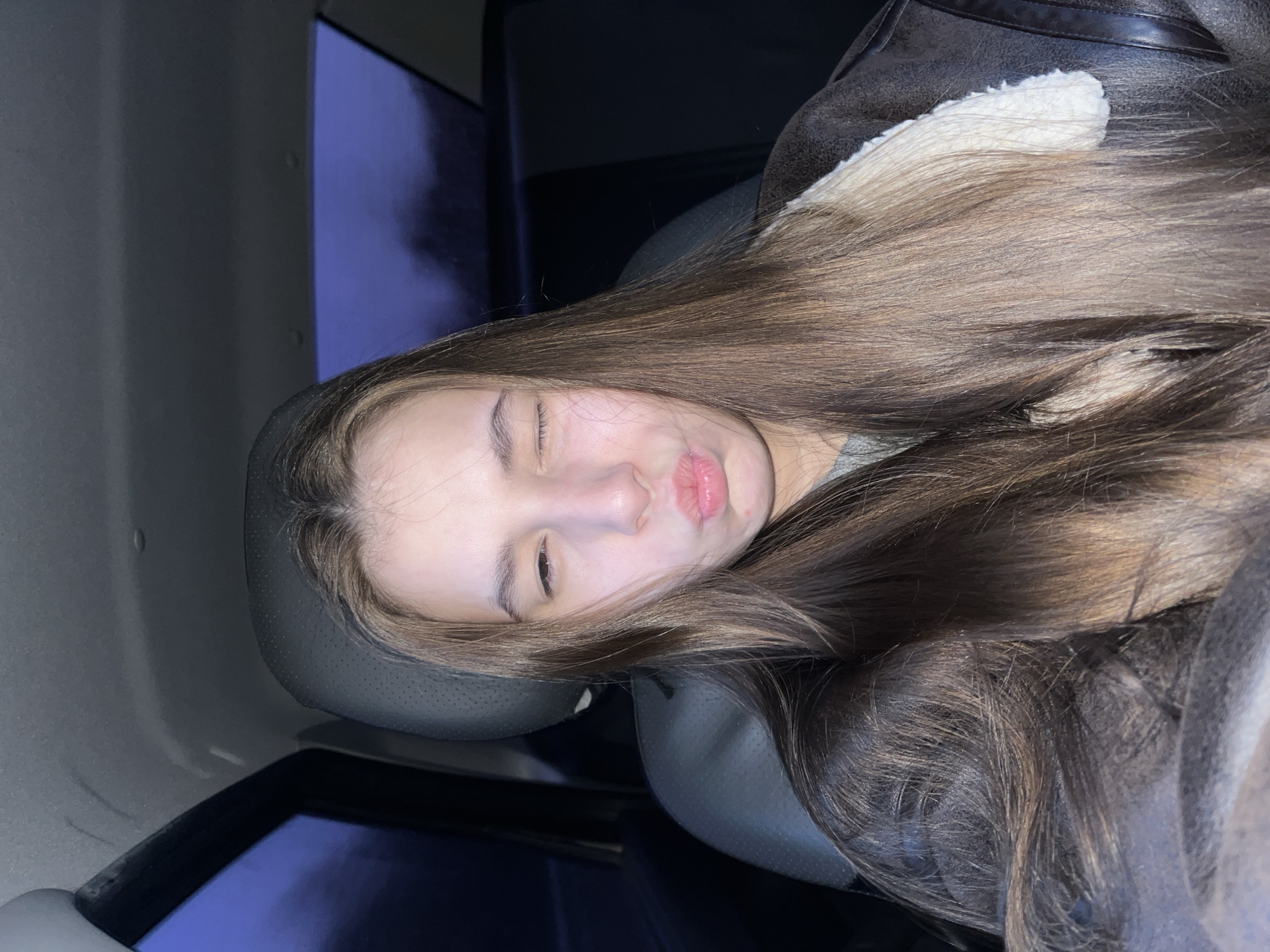 Woman rests in car back seat in Chaikovsky