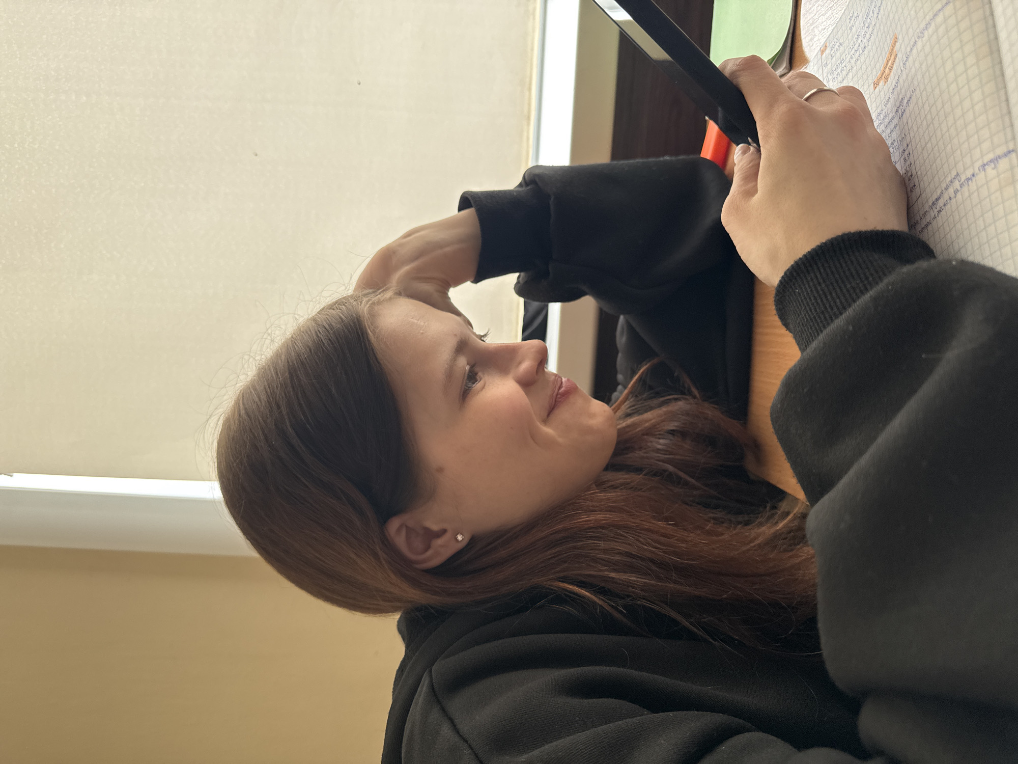 Woman with reddish hair observed in profile in Perm