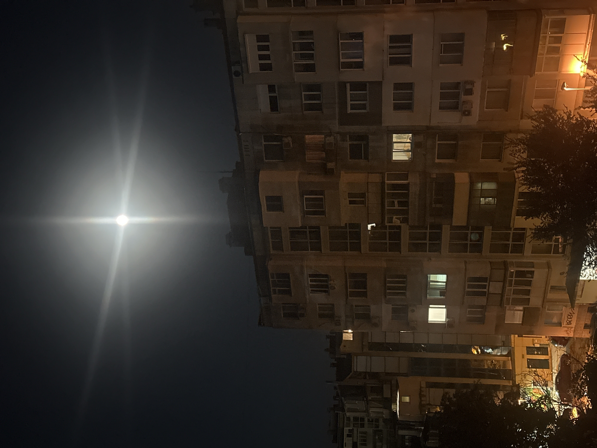 Full moon night over an apartment complex and playground