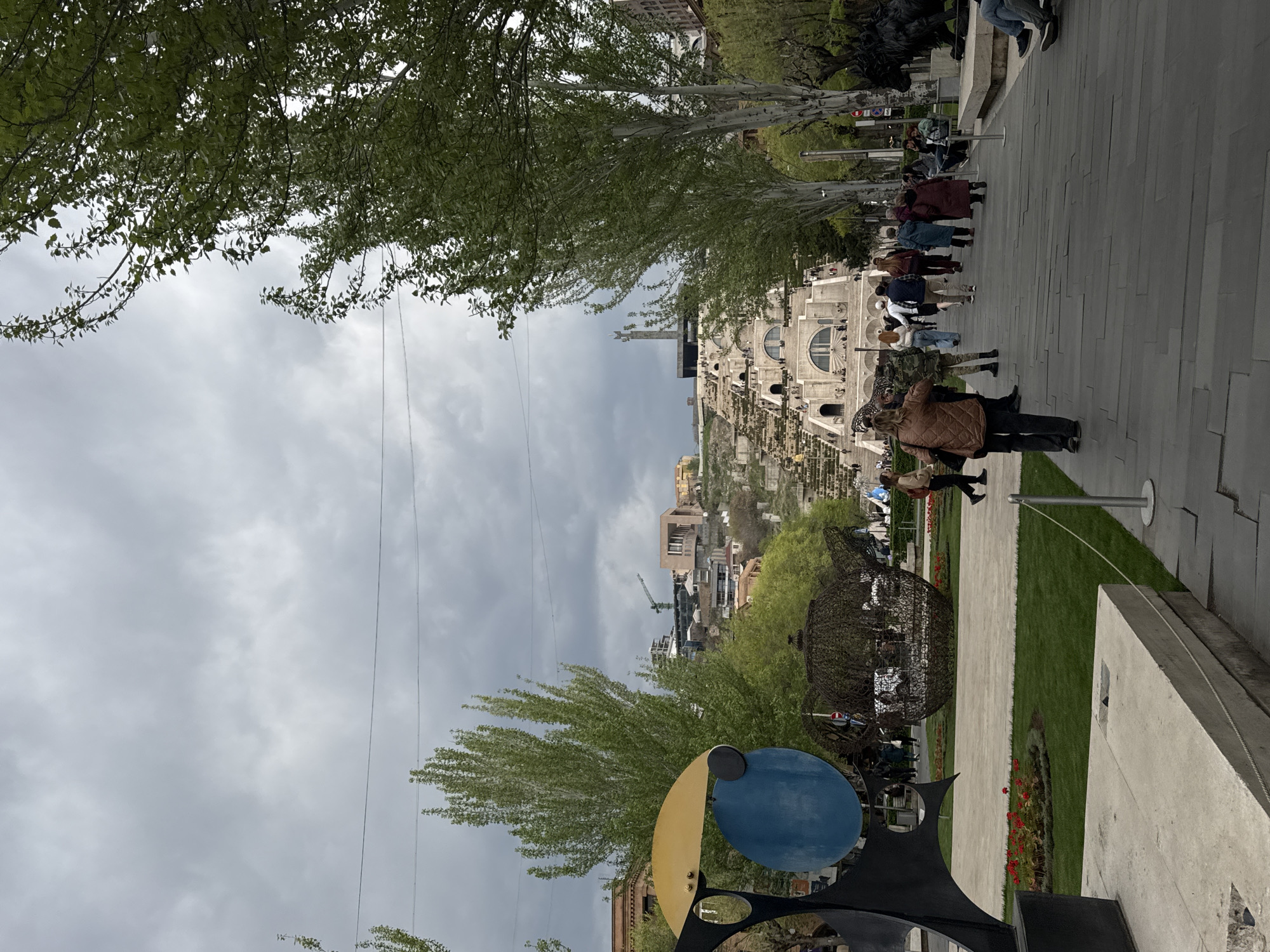 Pedestrians gather at Yerevan Cascade plaza under cloudy skies