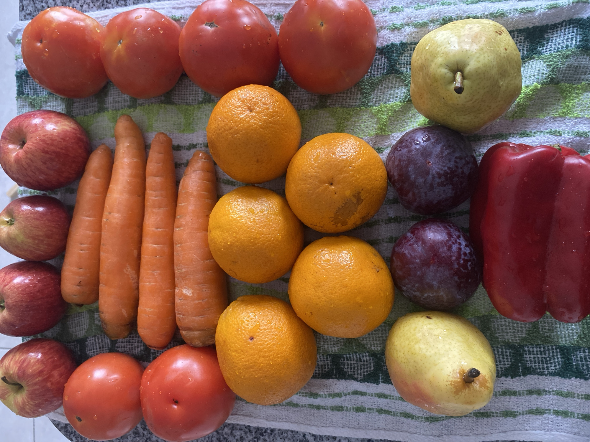 Fresh produce arranged on striped towel documented in Argentina