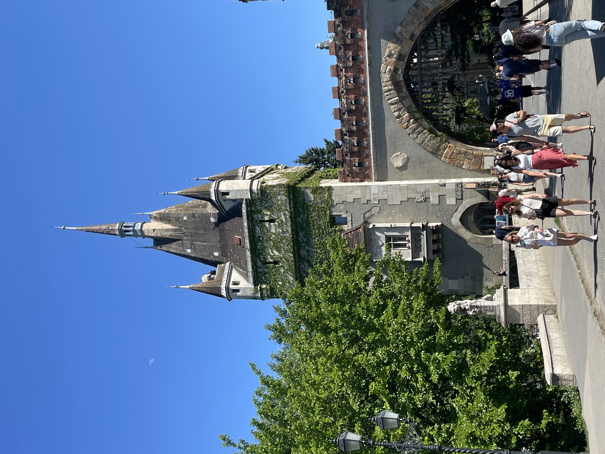Tourists document Budapest landmarks during midday sightseeing