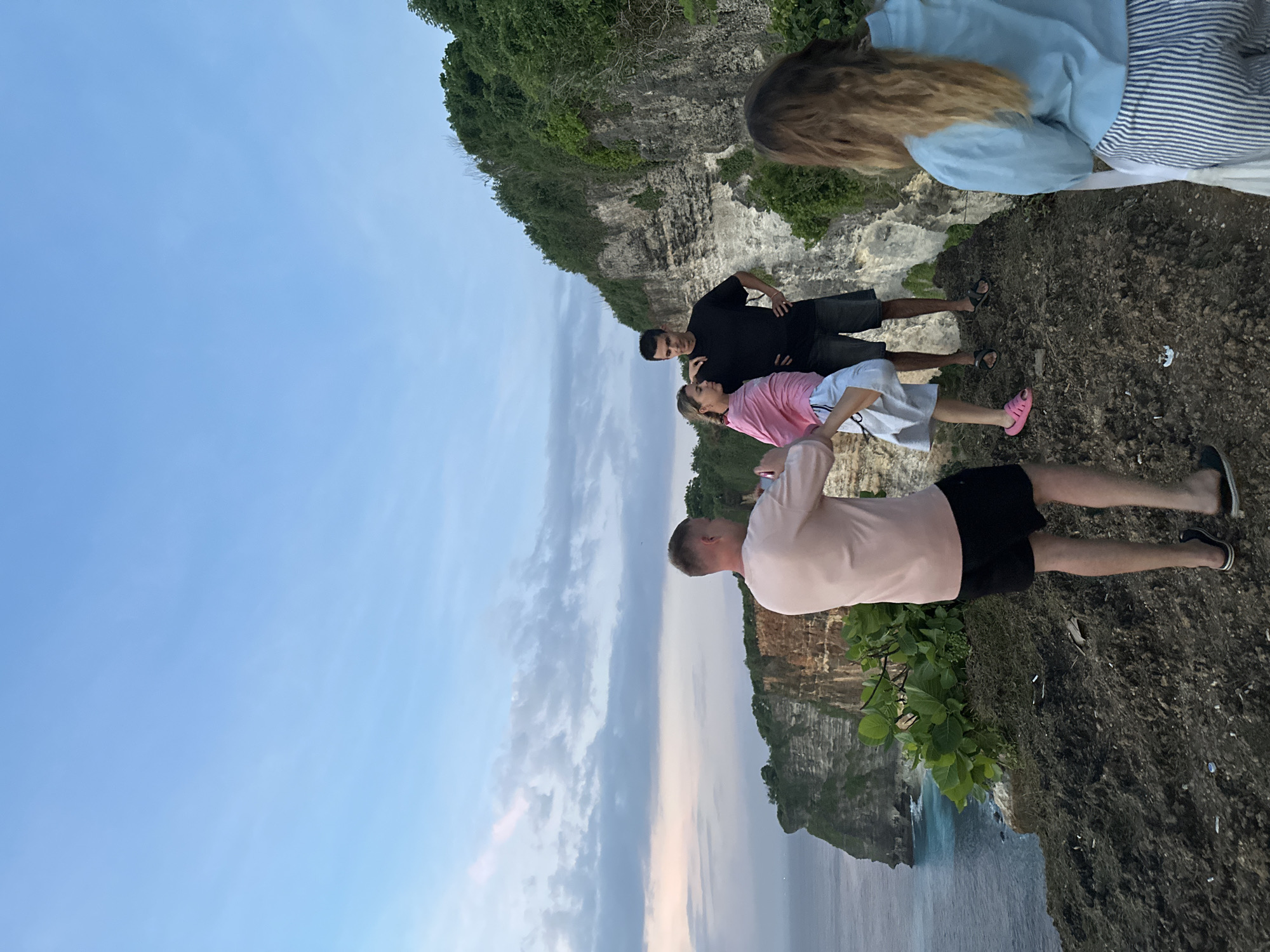 Five people gather on cliffside in Kuta Selatan