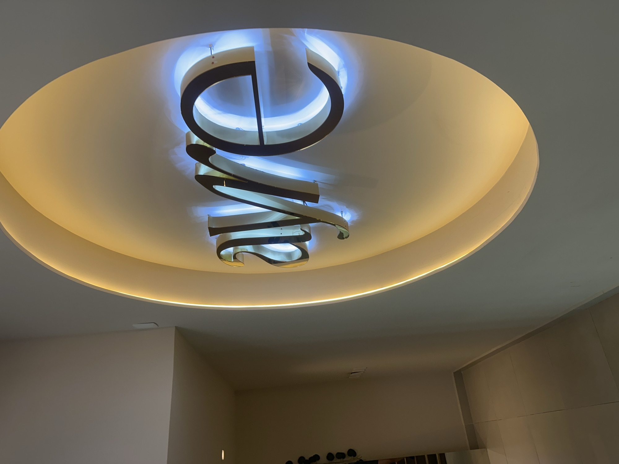 Woman documents modern building interior in San Bernardino Tlaxcalancingo
