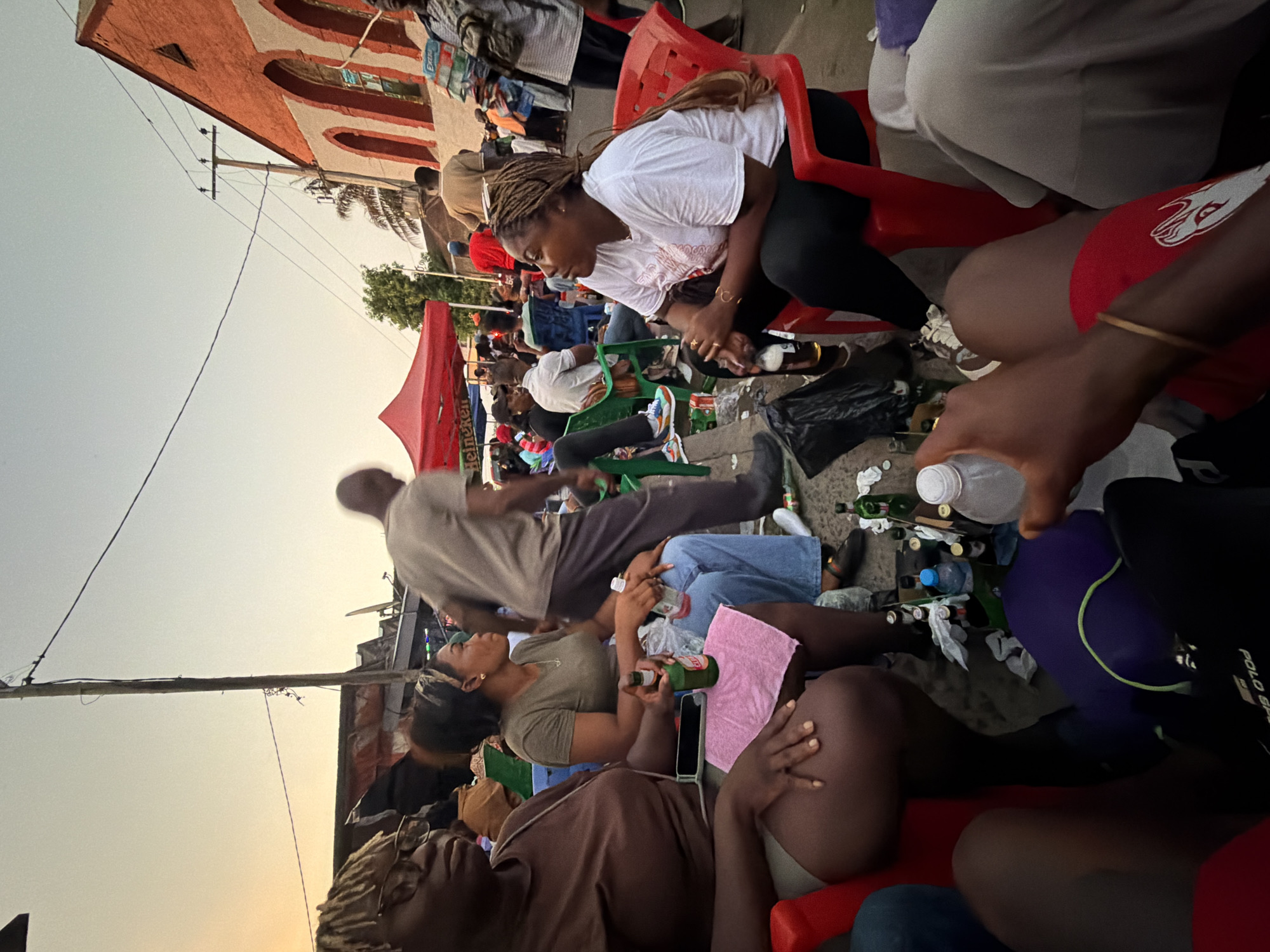 Outdoor beer gathering observed in Monrovia under Heineken tent