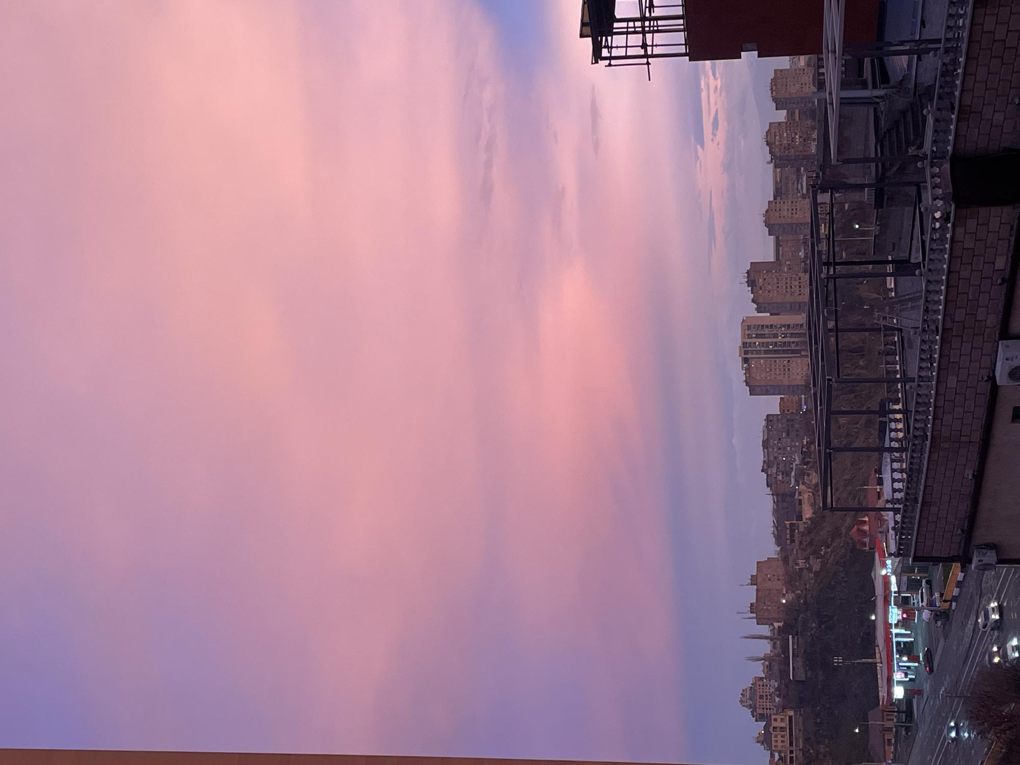 Vibrant pink-purple twilight sky observed over Yerevan, Armenia