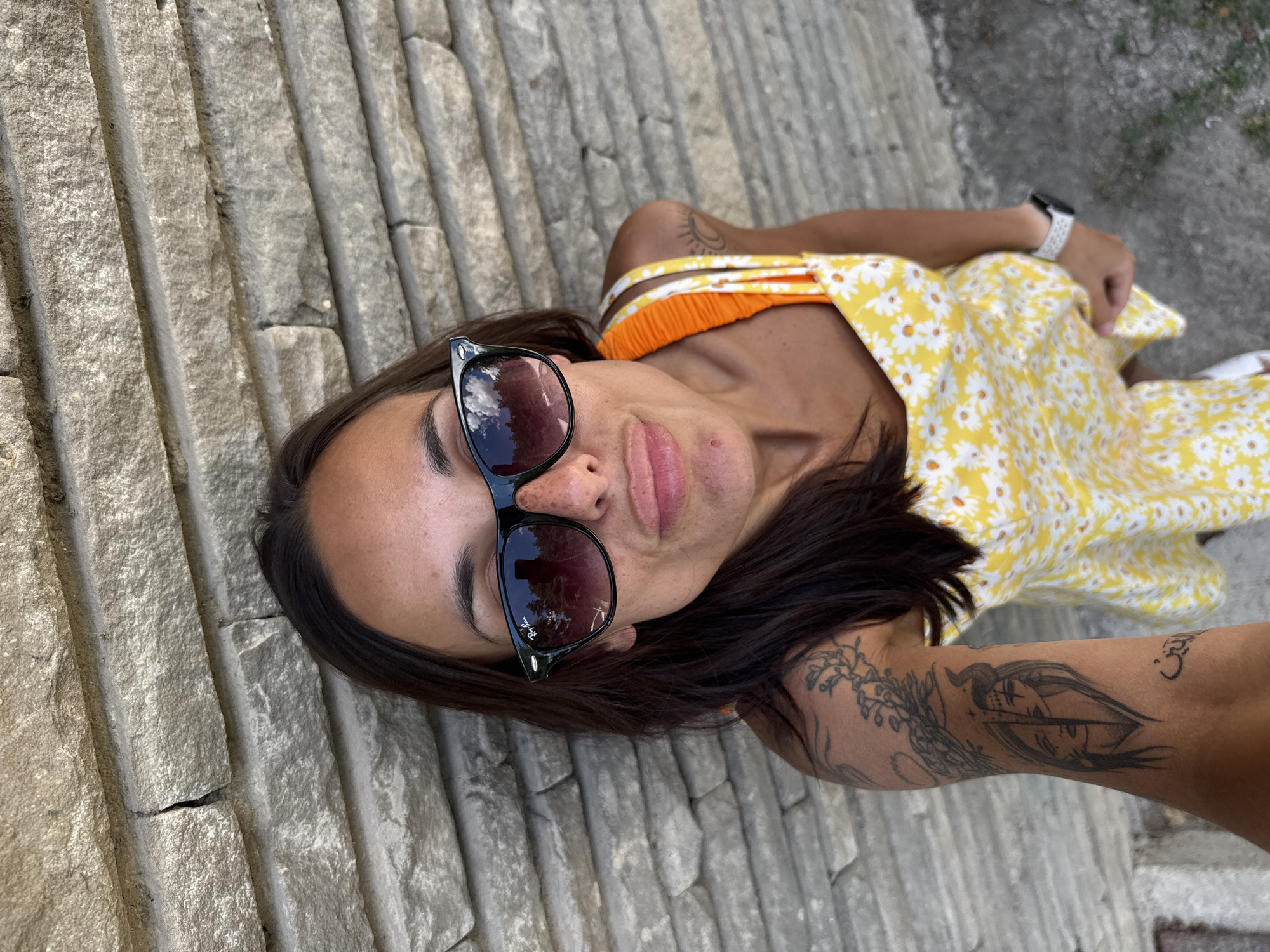 Yellow dress, stone walls, and blue skies in Grivitsa