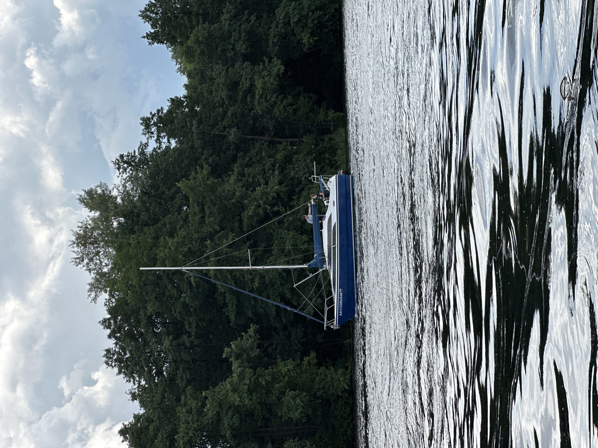 Blue sailboat anchored on a choppy lake near Lipetsk