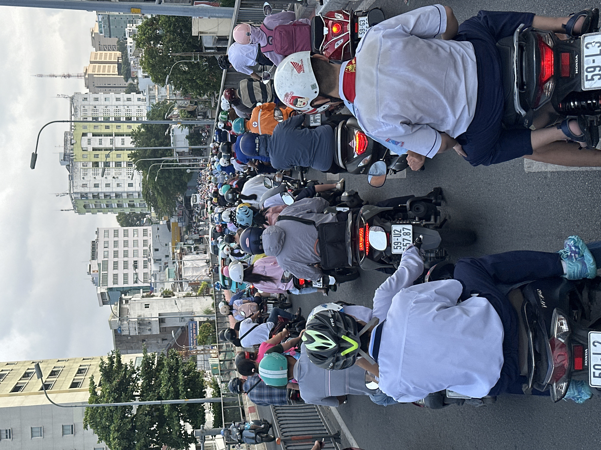 Dense motorcycle traffic clogs Ho Chi Minh City bridge