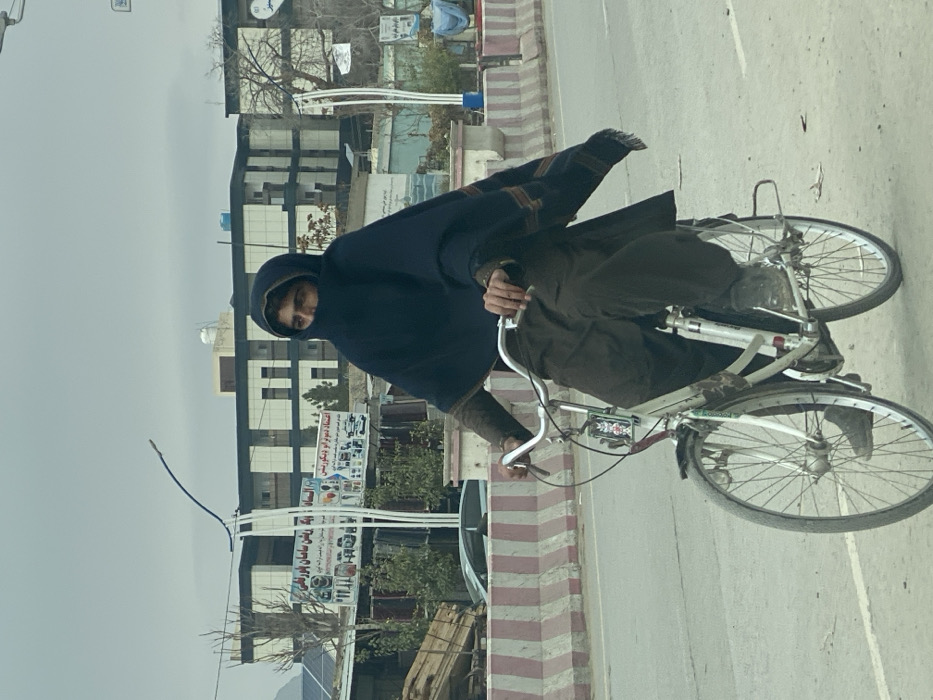 Morning street traffic observed in Kandahar under cloudy skies
