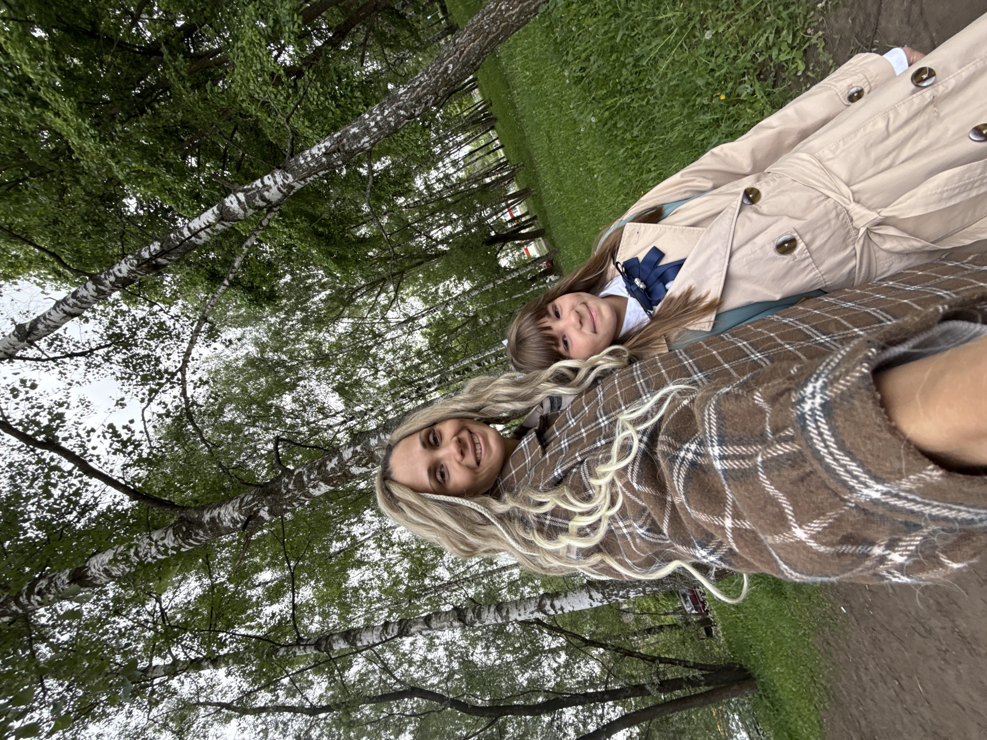 Two women photographed in birch forest near Rusanovo, Russia