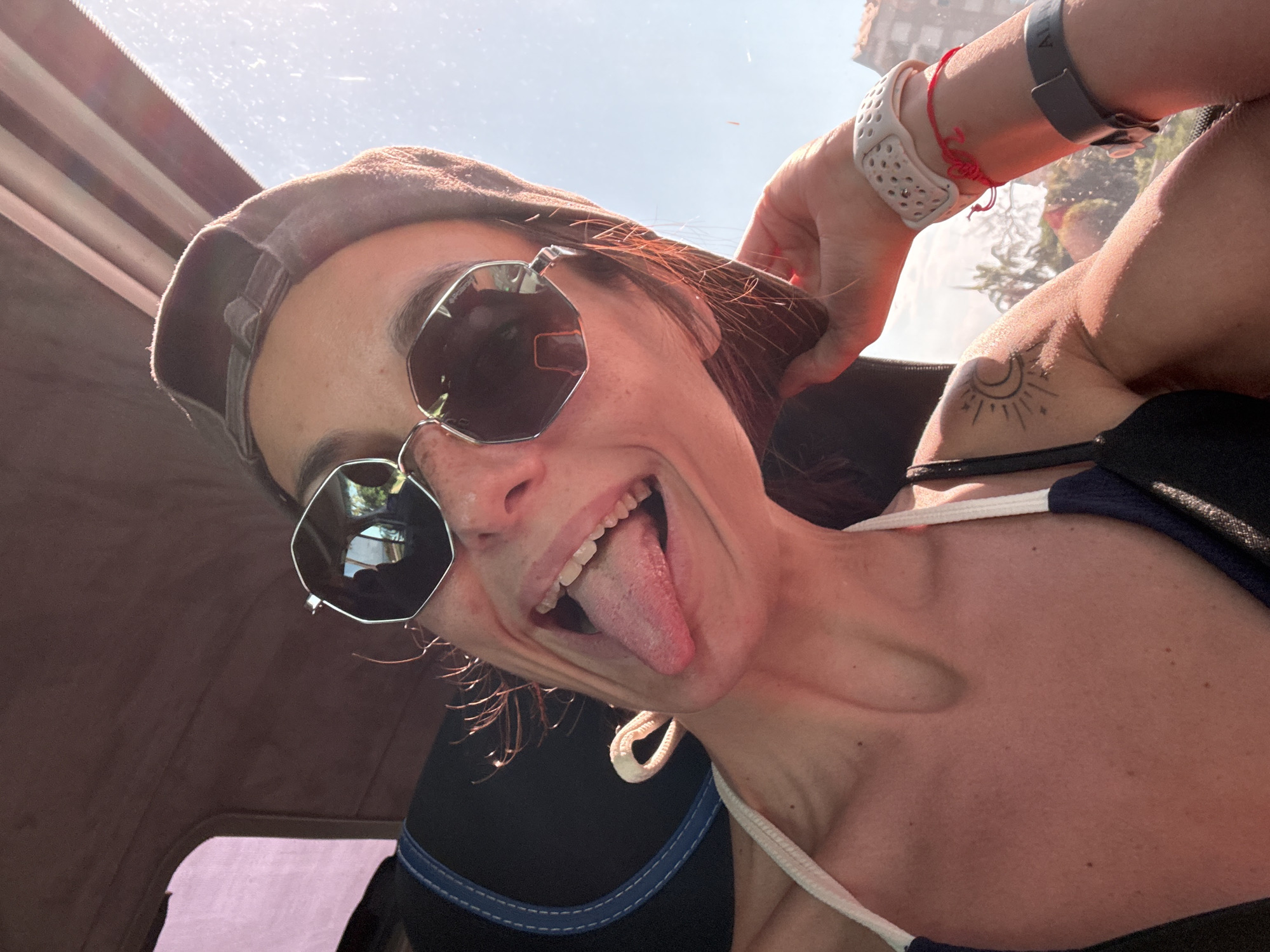 Goofy low-angle selfie in Antalya, sunglasses and tongue out.