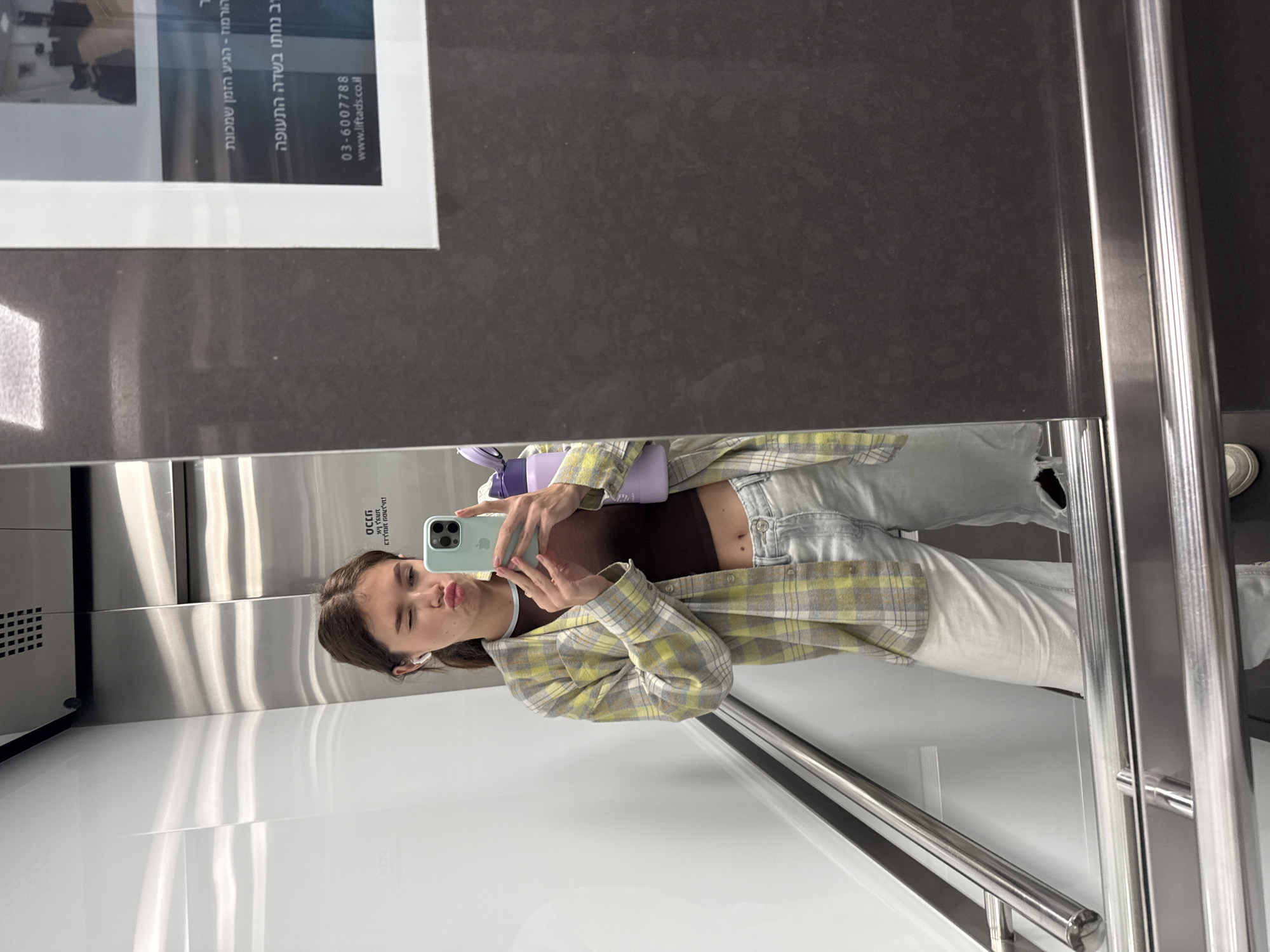 Woman takes selfies in elevator and vanity mirror in Ramat Gan