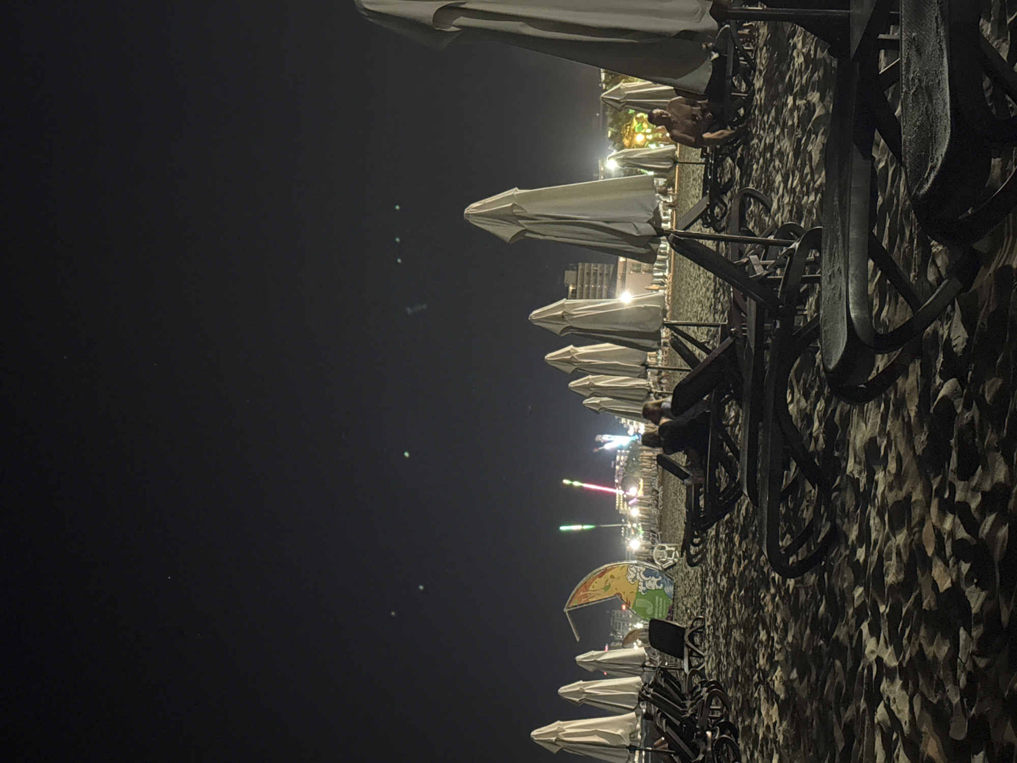Summer night on Nesebar beach with a Ferris wheel glowing