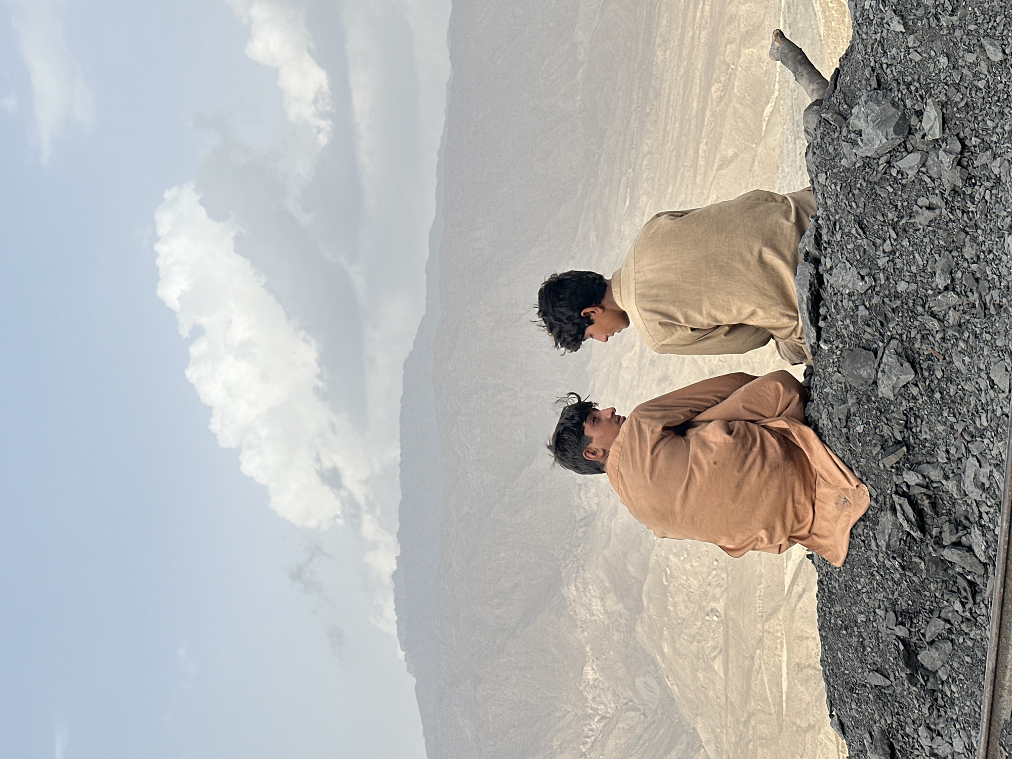 Sitting on a coal mound in Quetta, Pakistan.