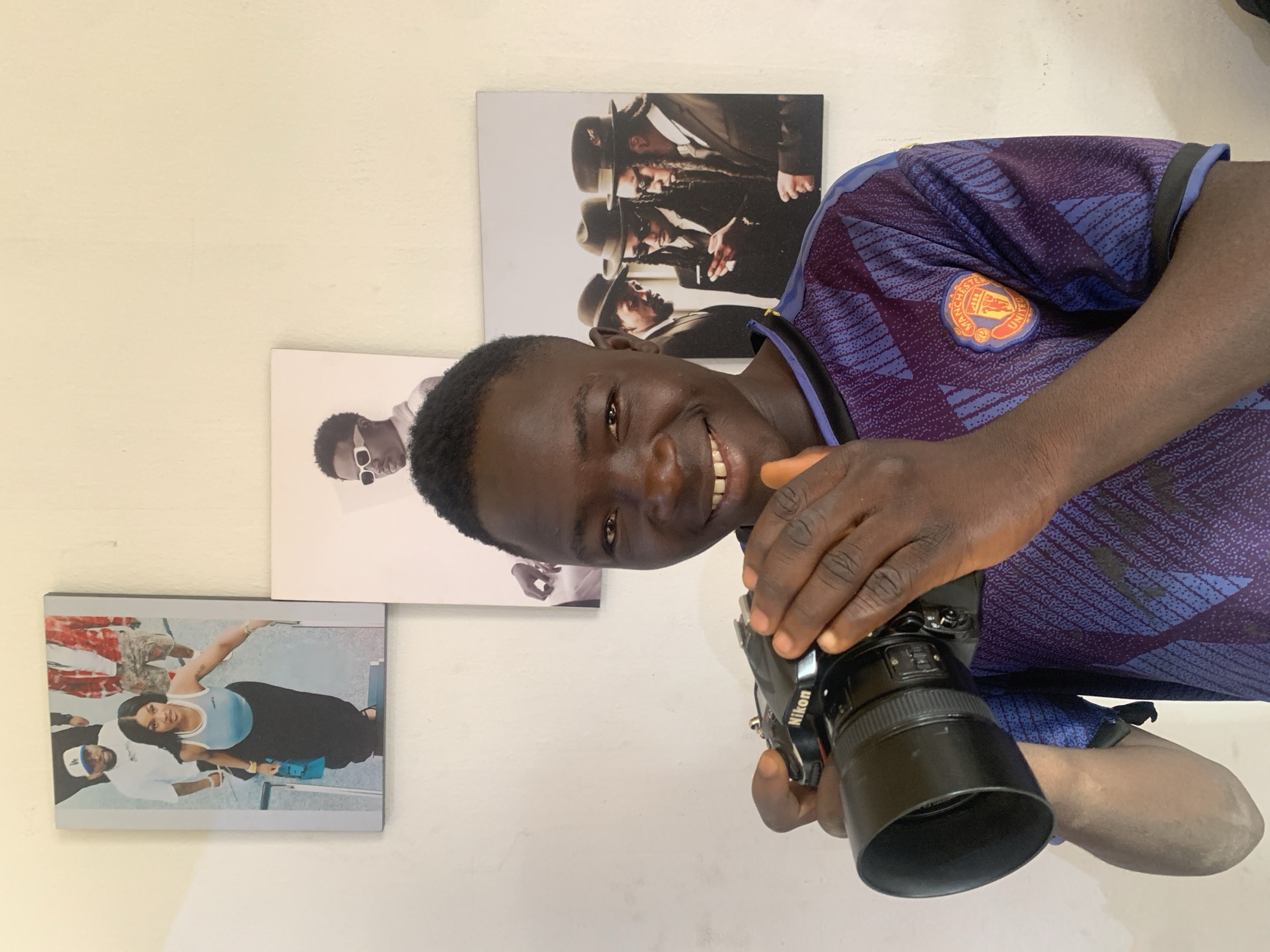 Young photographer in Manchester United jersey captured in Jos
