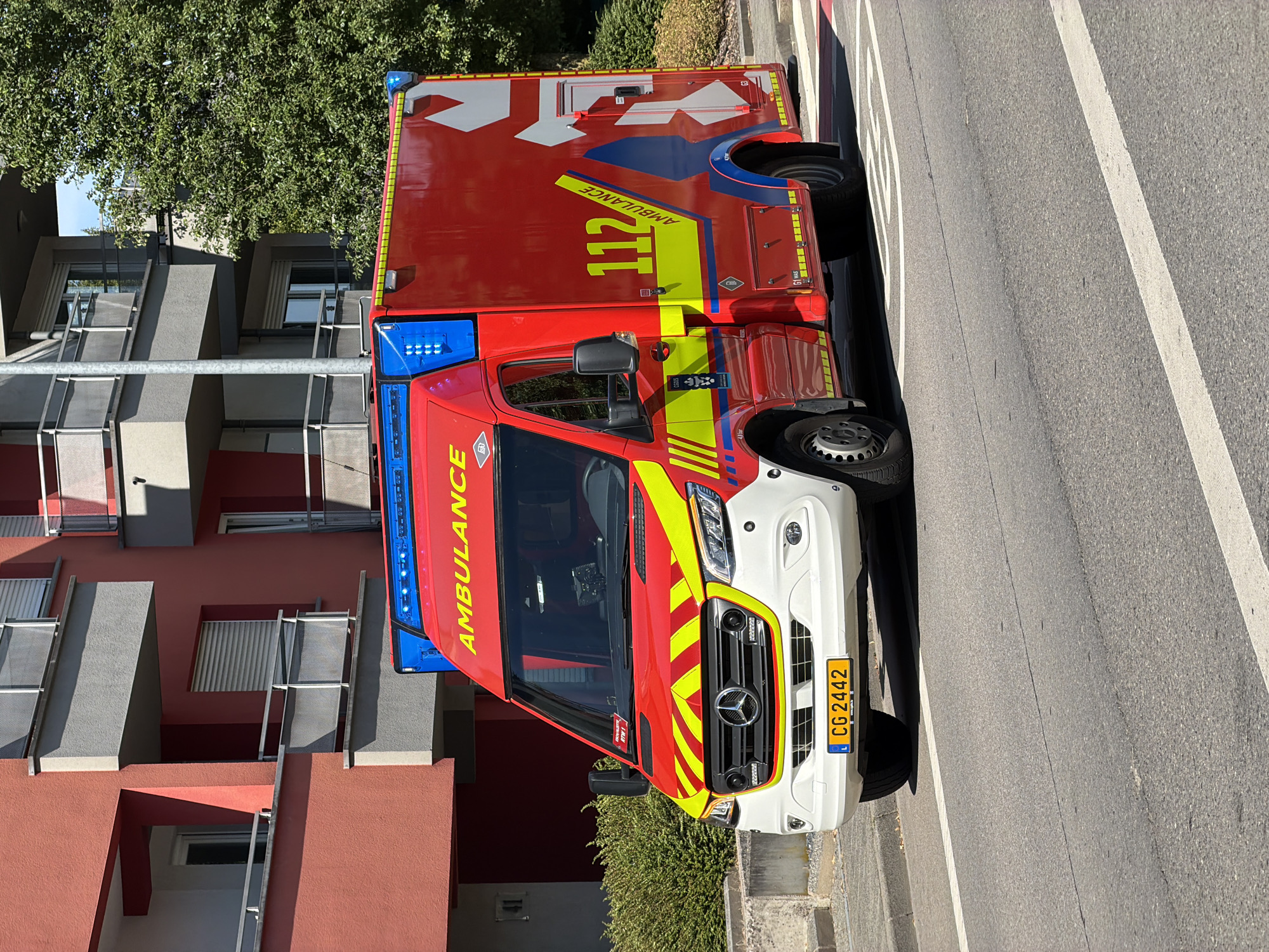 Red ambulance parked on a street in Esch-sur-Alzette, Luxembourg