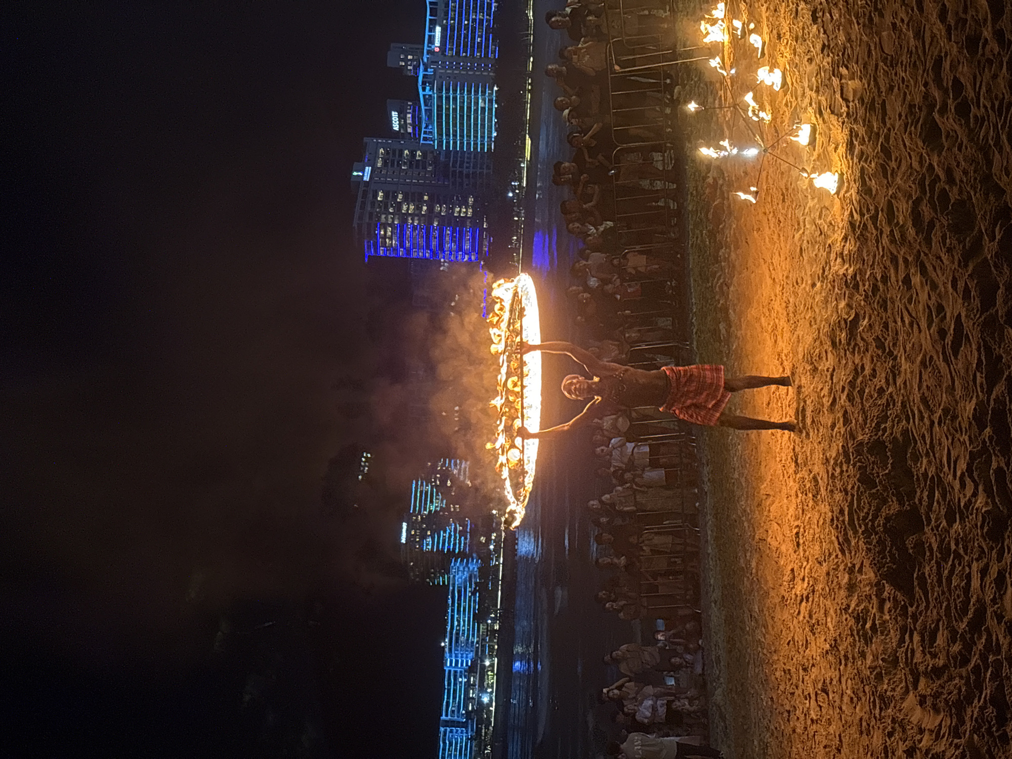 Beach fire performance lights up the Jiyang District shoreline at night