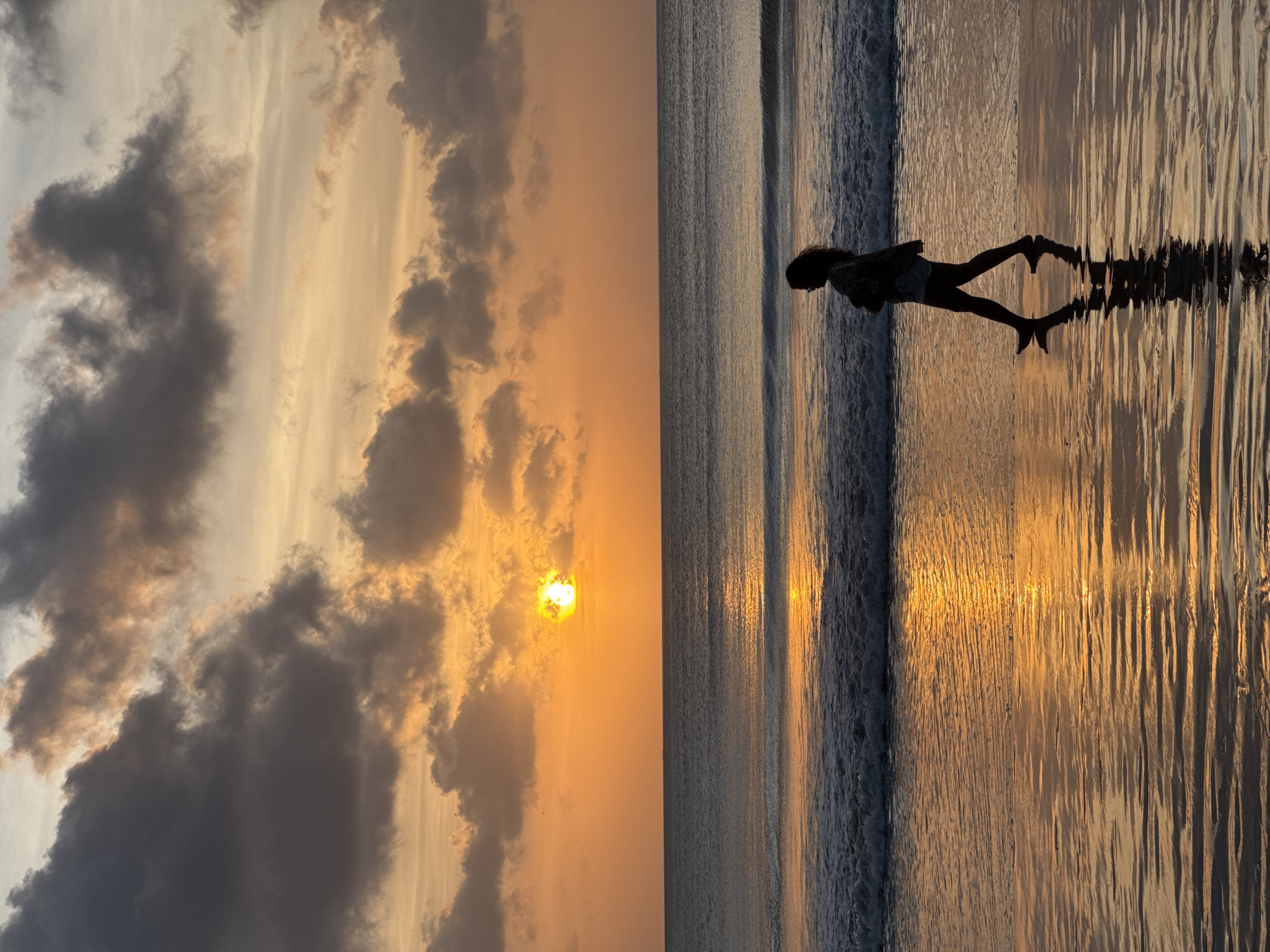 Beach life unfolds at Kuta Selatan during sunset hour