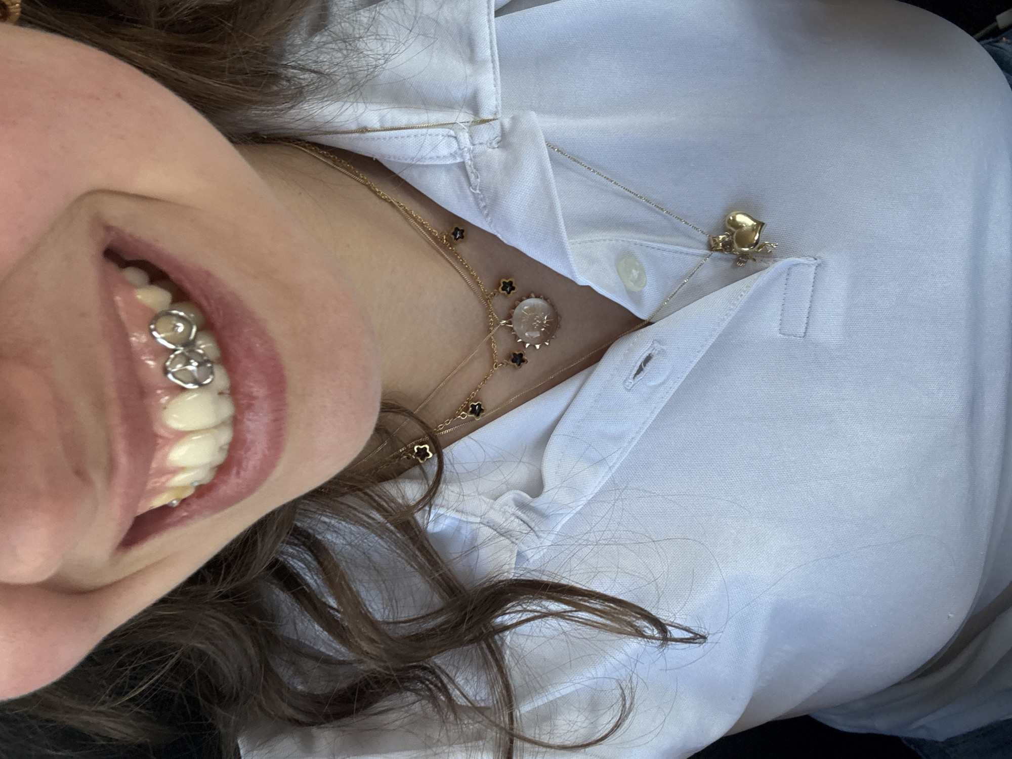 Person in white shirt photographed smiling in Milan
