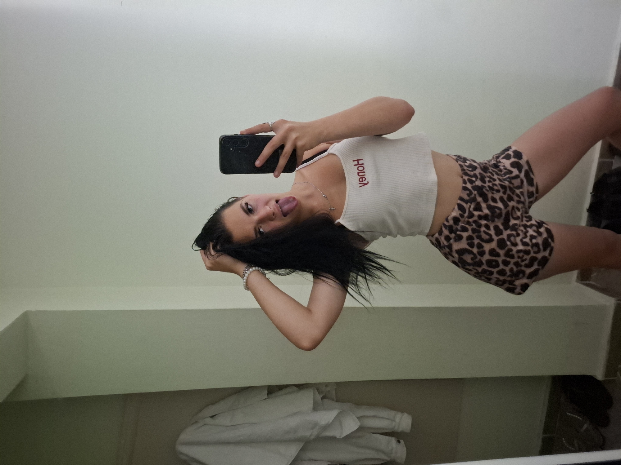 Mirror selfie in Varna bedroom, leopard print and red lettering
