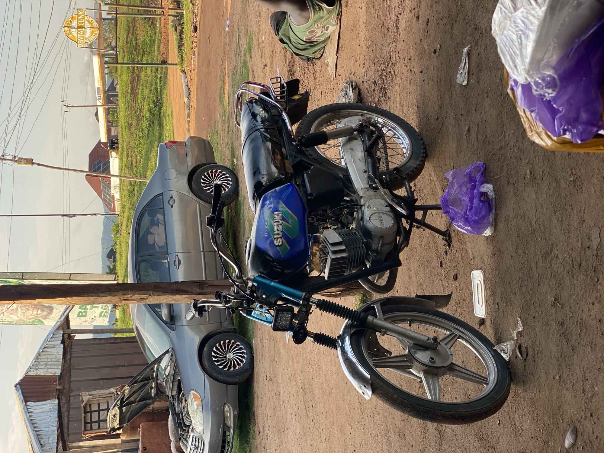 Daily life moments captured around motorcycle repair shop in Jalingo