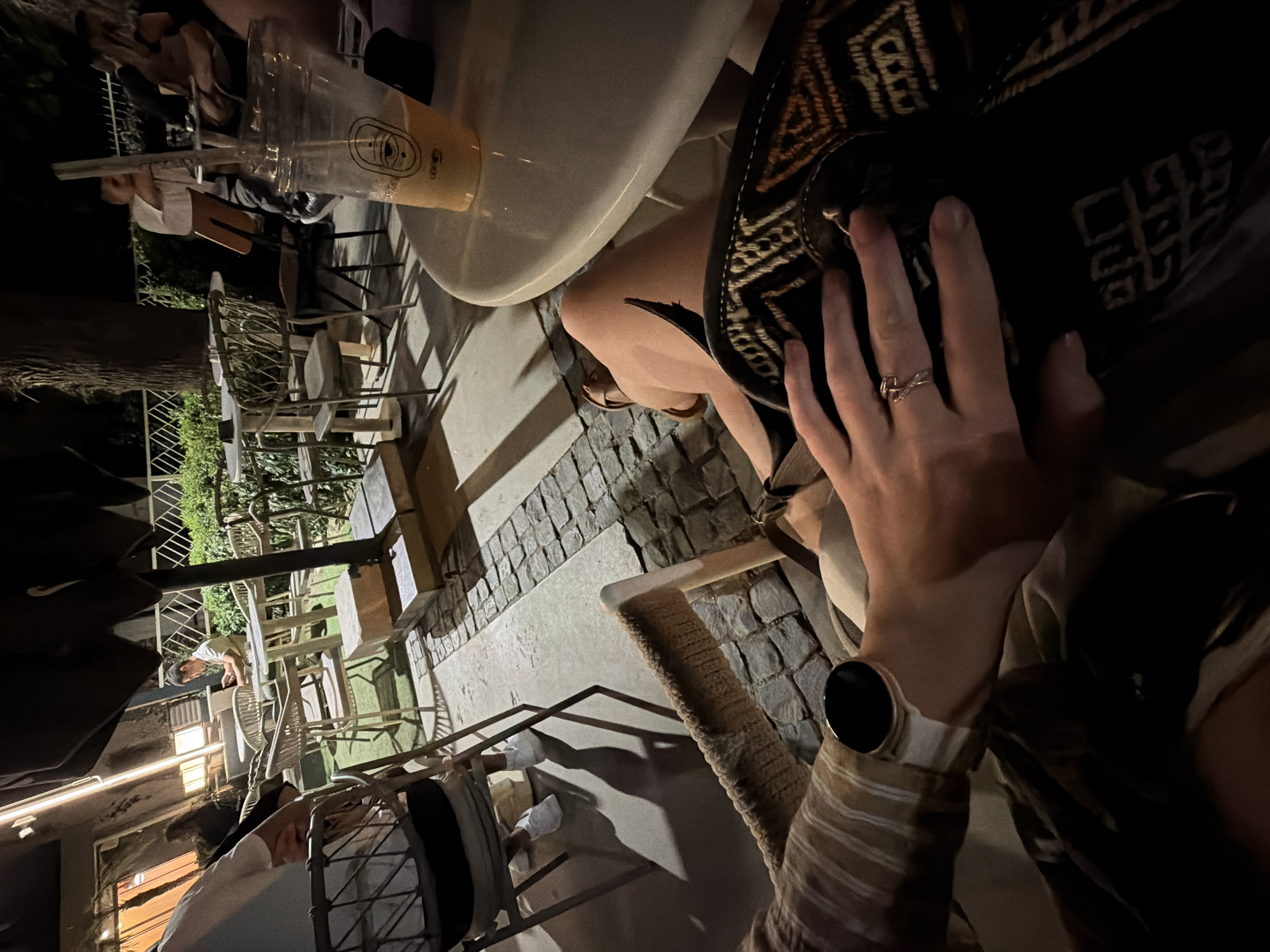 Evening at an İzmir café, patterned bag and smartwatch on the table