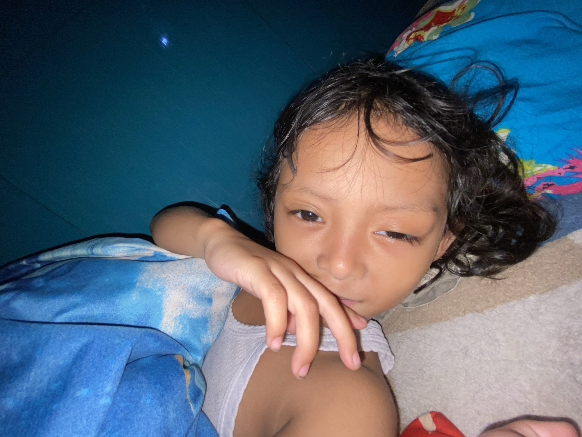Child resting peacefully at home in Gelam, Indonesia