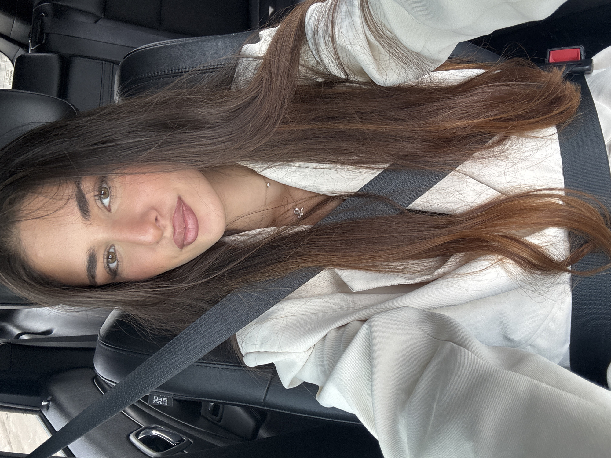 Woman in white jacket photographed in car, North Miami Beach