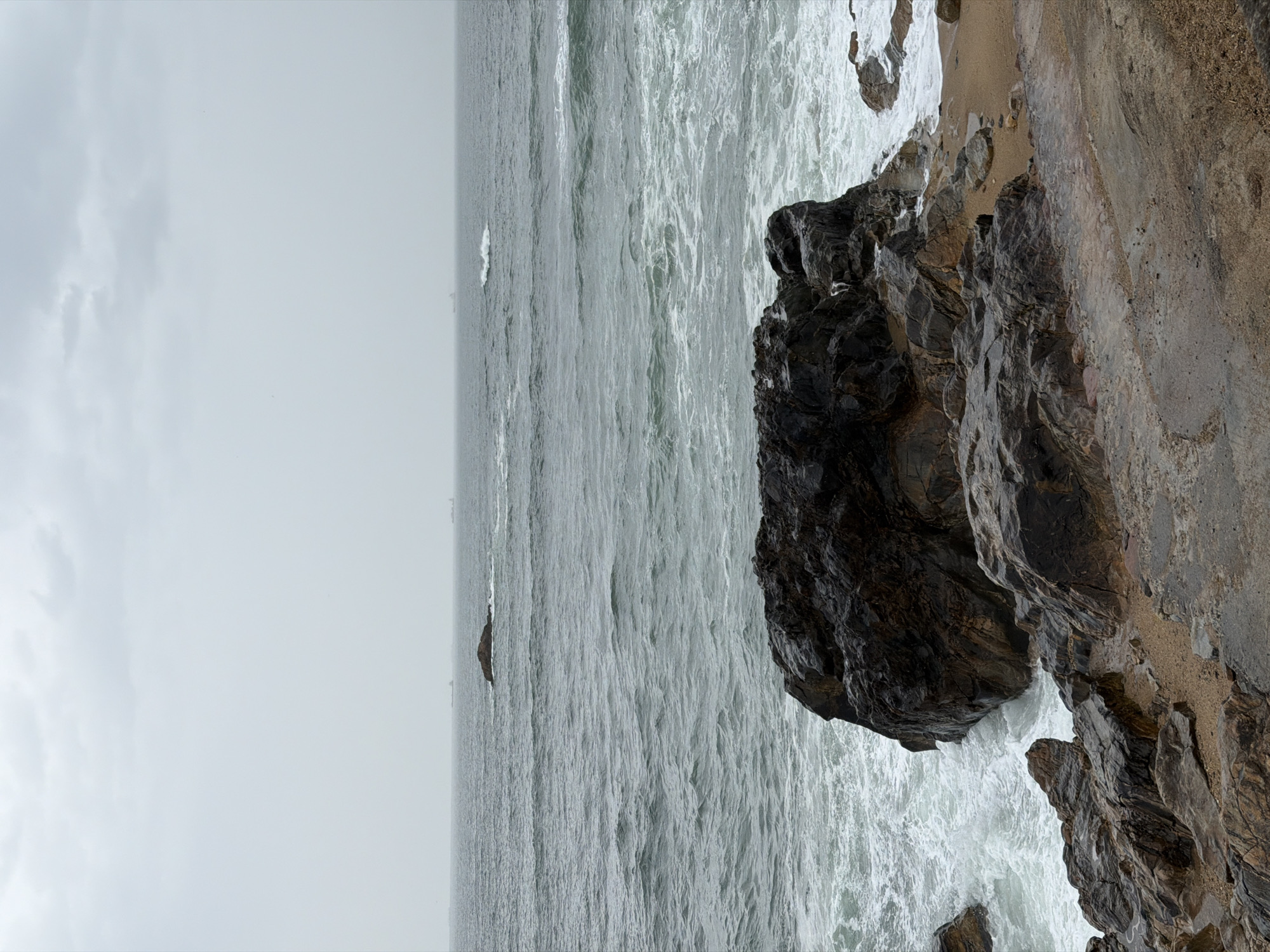 Turbulent waves batter Porto coastline under overcast skies
