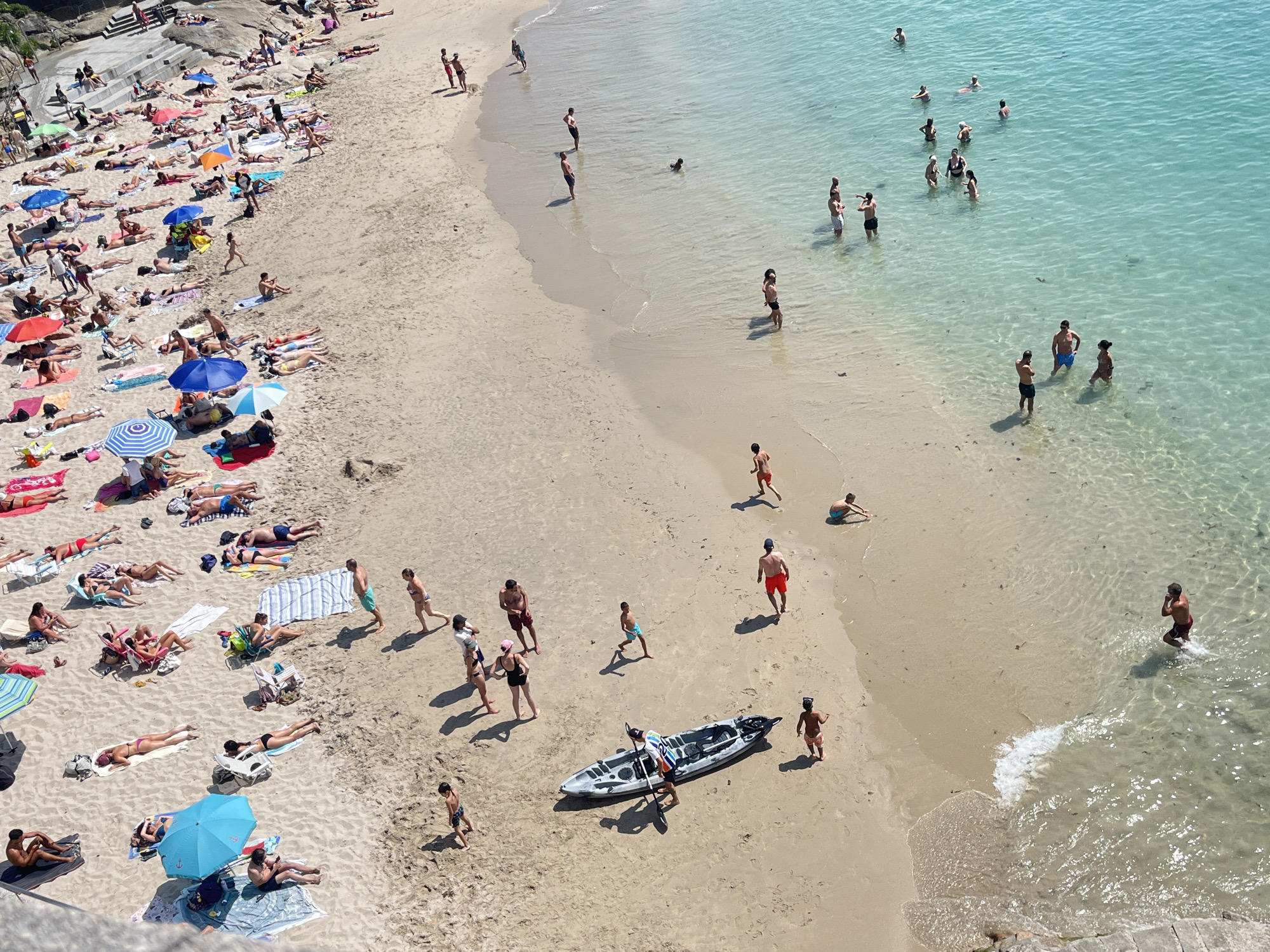 Packed summer beach day in A Coruña, Spain