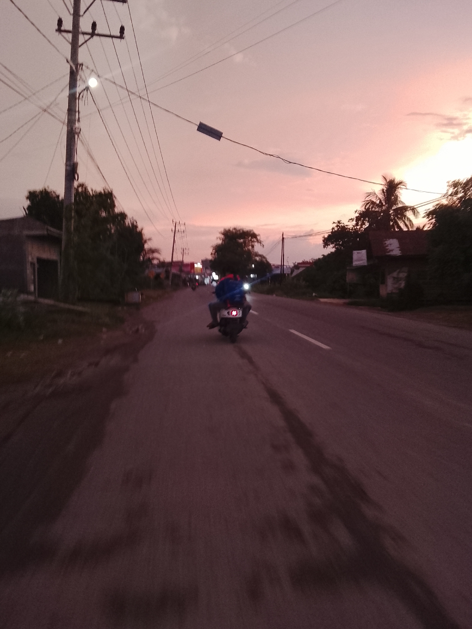 Evening scooter ride through Aceh villages at dusk