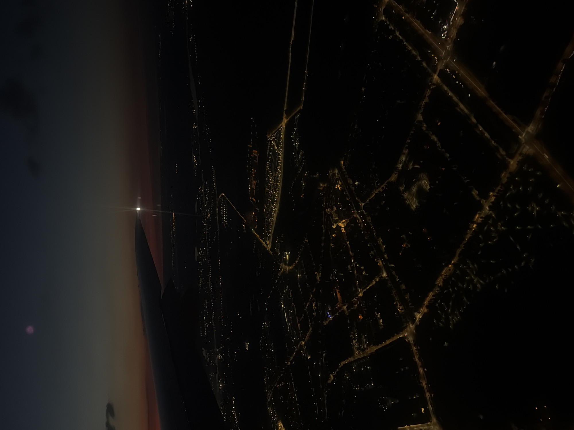 Airplane passenger captures sunset city view over Шемякино, Russia