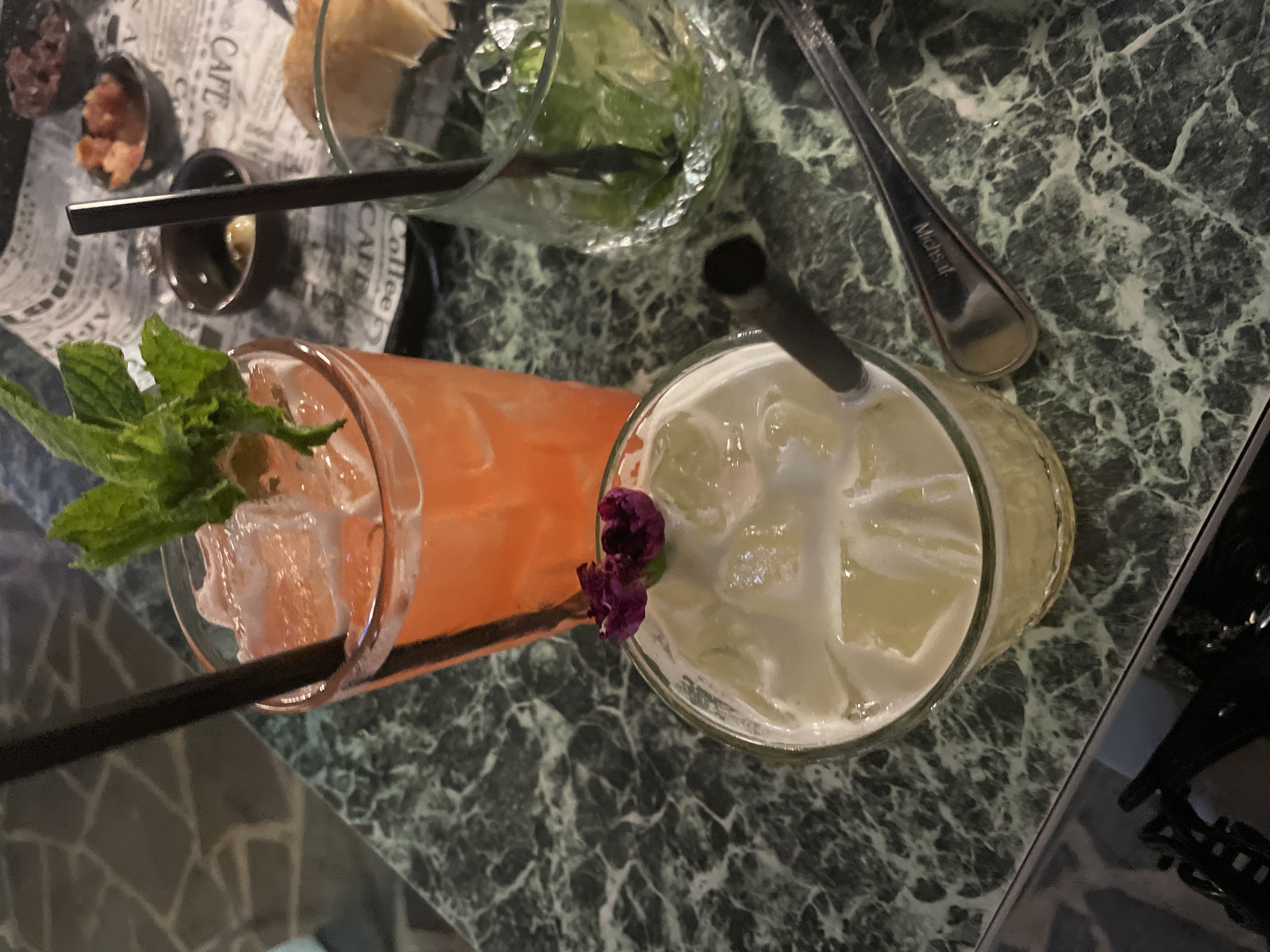 Three drinks served on marble table in Herzliya