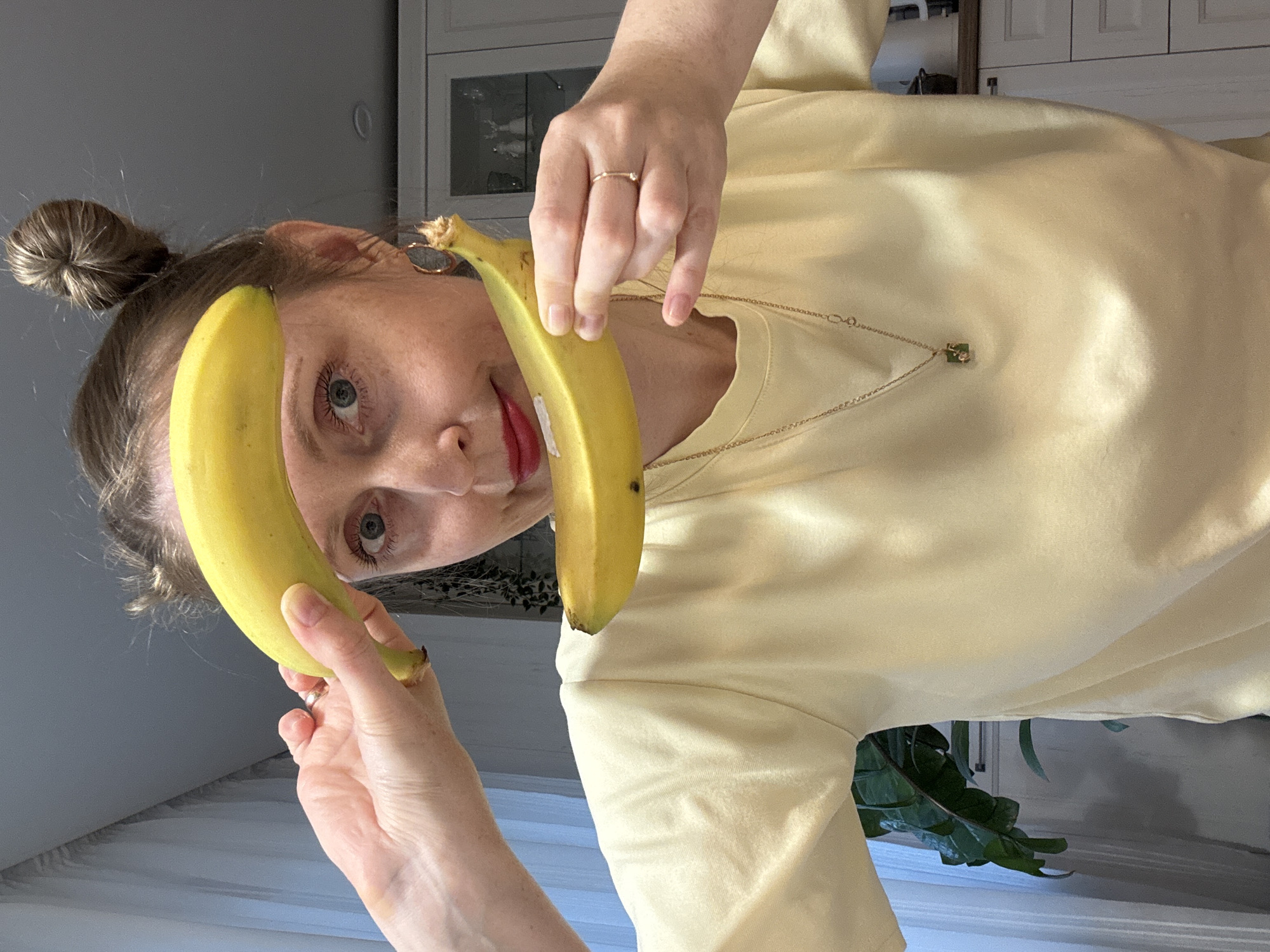 Woman and child play with fruit in Russian kitchen