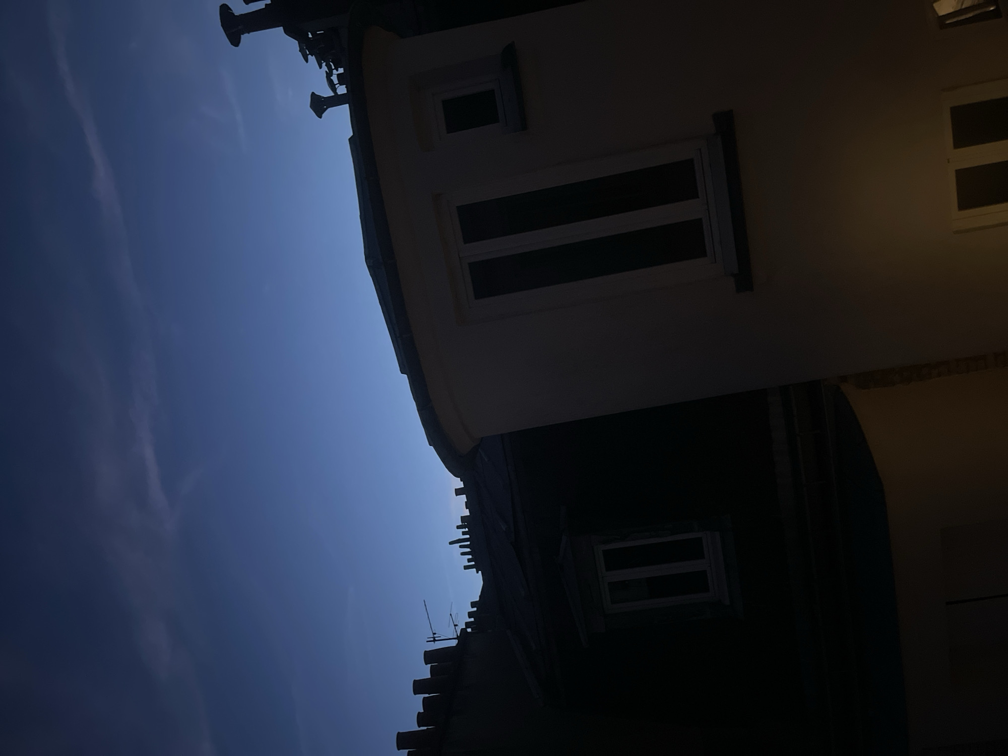 Parisian rooftops and a brass doorknob at dusk
